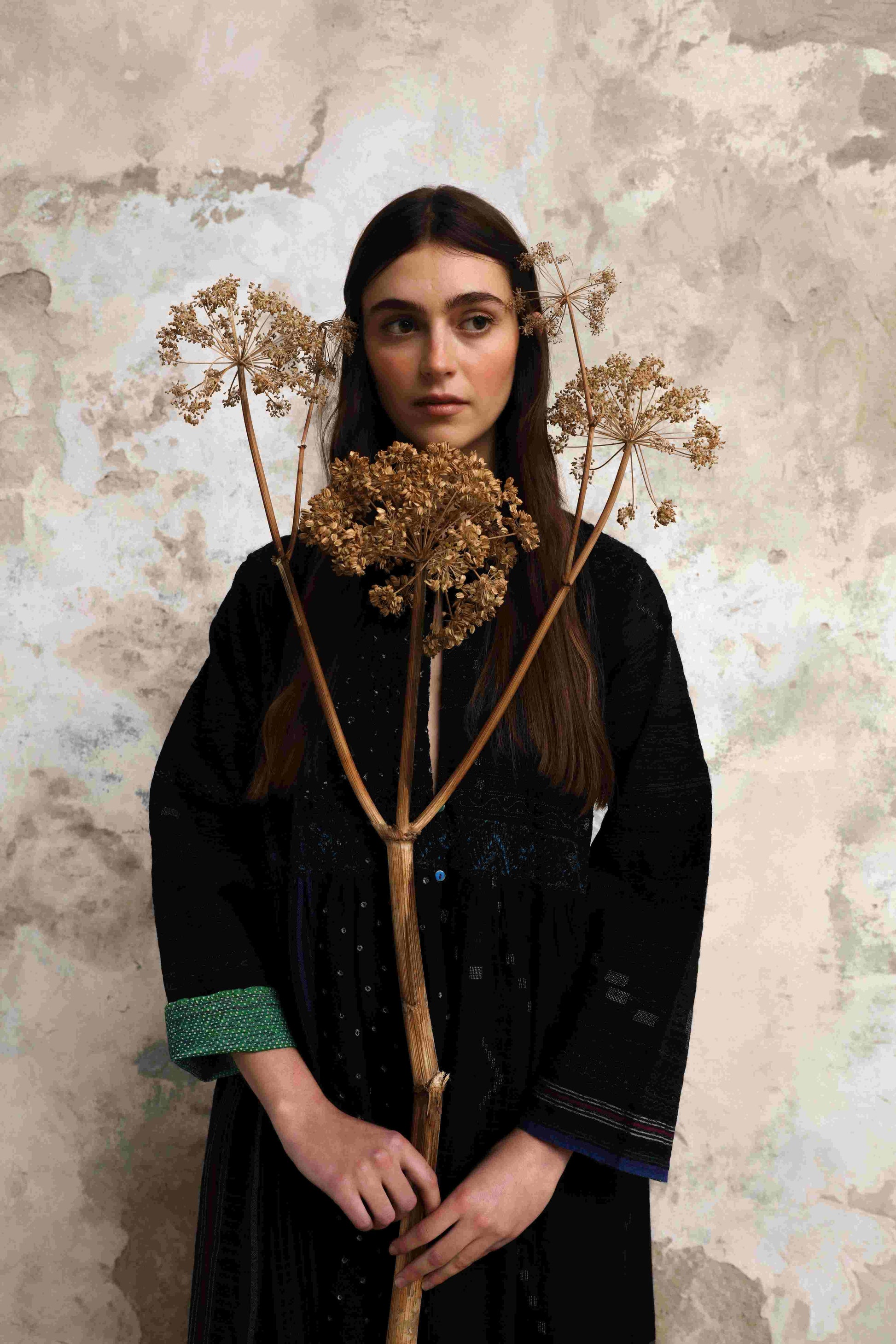Model is wearing the Folklore 20 handloomed silk and wool dress by Injiri, featuring a flattering cut, long sleeves, side pockets, and artisan-made handloomed fabric.
