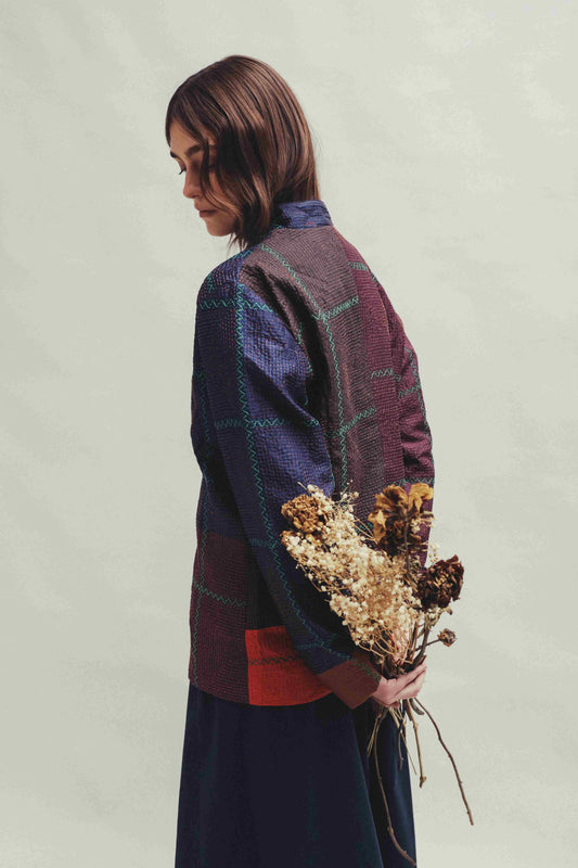 Model is wearing the Folklore 82 silk hand-loomed jacket by Injiri, featuring lightweight silk, refined tailoring, and artisanal craftsmanship, handmade in India. Part of House of Woven Stories selection.