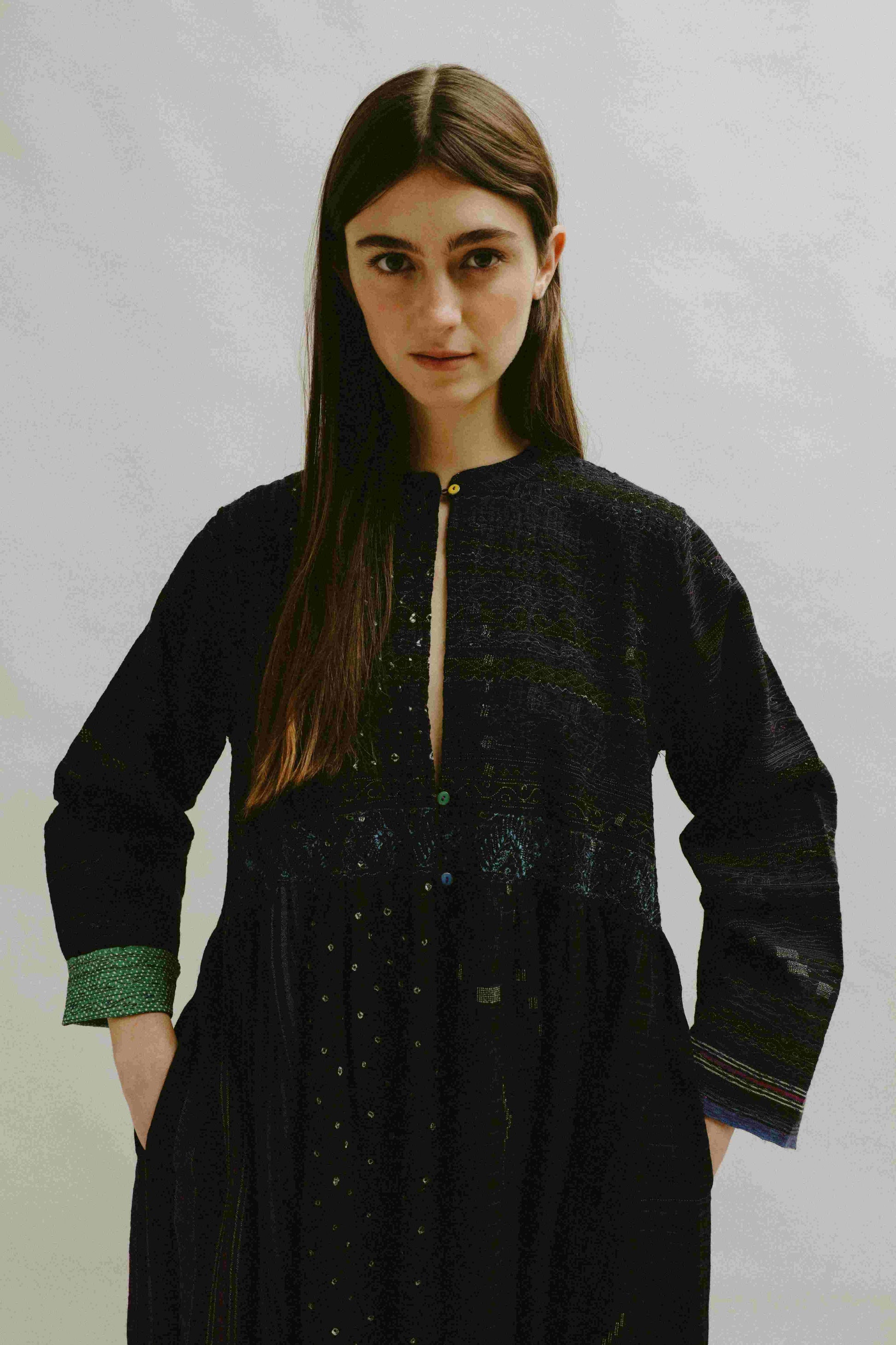 Model is wearing the Folklore 20 handloomed silk and wool dress by Injiri, featuring a flattering cut, long sleeves, side pockets, and artisan-made handloomed fabric.