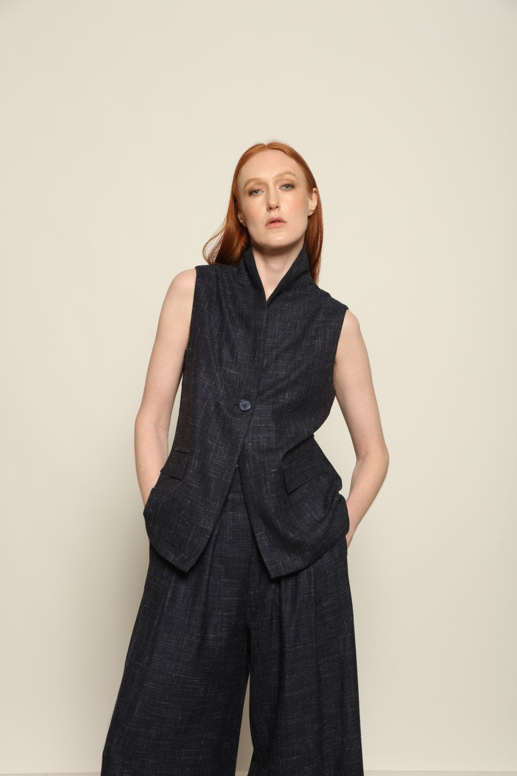Model is wearing the Franca night blue and white gilet from the House of Woven Stories selection, a women’s tailored waistcoat made in Italy in Piedmont with a softly structured silhouette, designed for fluid layering and ethical contemporary fashion.