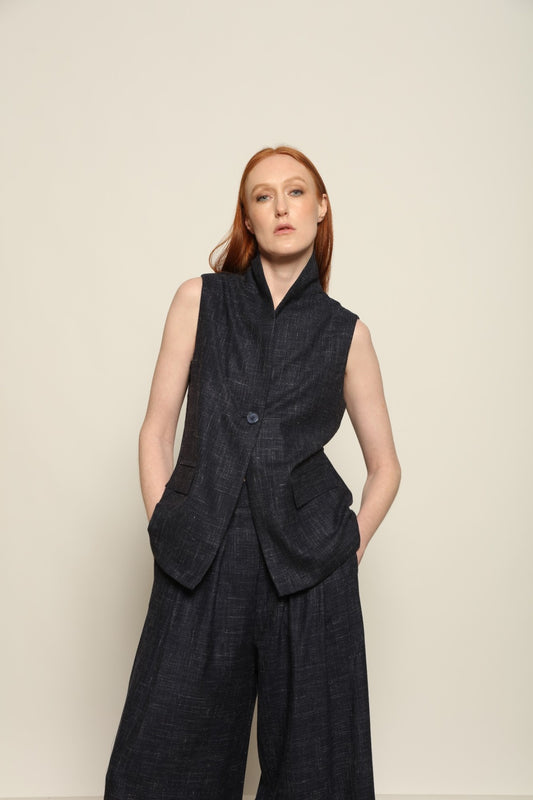 Model is wearing the Franca night blue and white gilet from the House of Woven Stories selection, a women’s tailored waistcoat made in Italy in Piedmont with a softly structured silhouette, designed for fluid layering and ethical contemporary fashion.