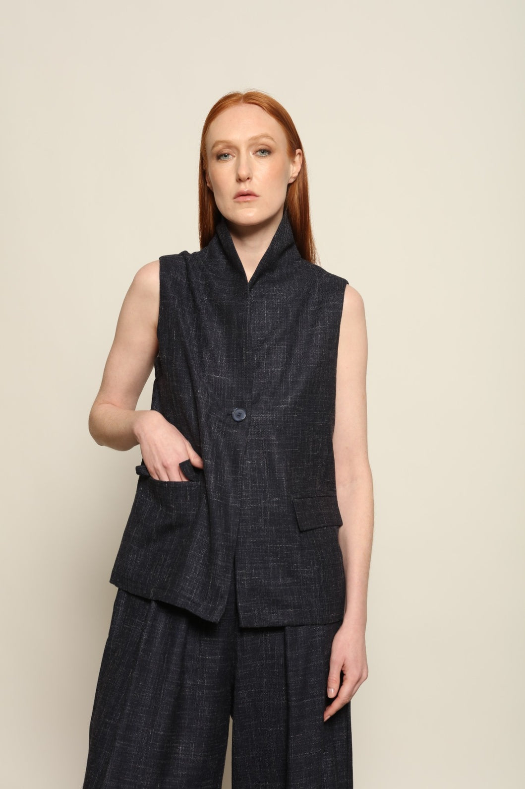 Model is wearing the Franca night blue and white gilet from the House of Woven Stories selection, a women’s tailored waistcoat made in Italy in Piedmont with a softly structured silhouette, designed for fluid layering and ethical contemporary fashion.