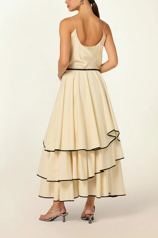 Model wearing a Frill Layer Skirt by Abadia from the House of Nomad Stories collection, featuring layered frill detailing, soft volume, and a flowing cotton blend silhouette with elegant movement.