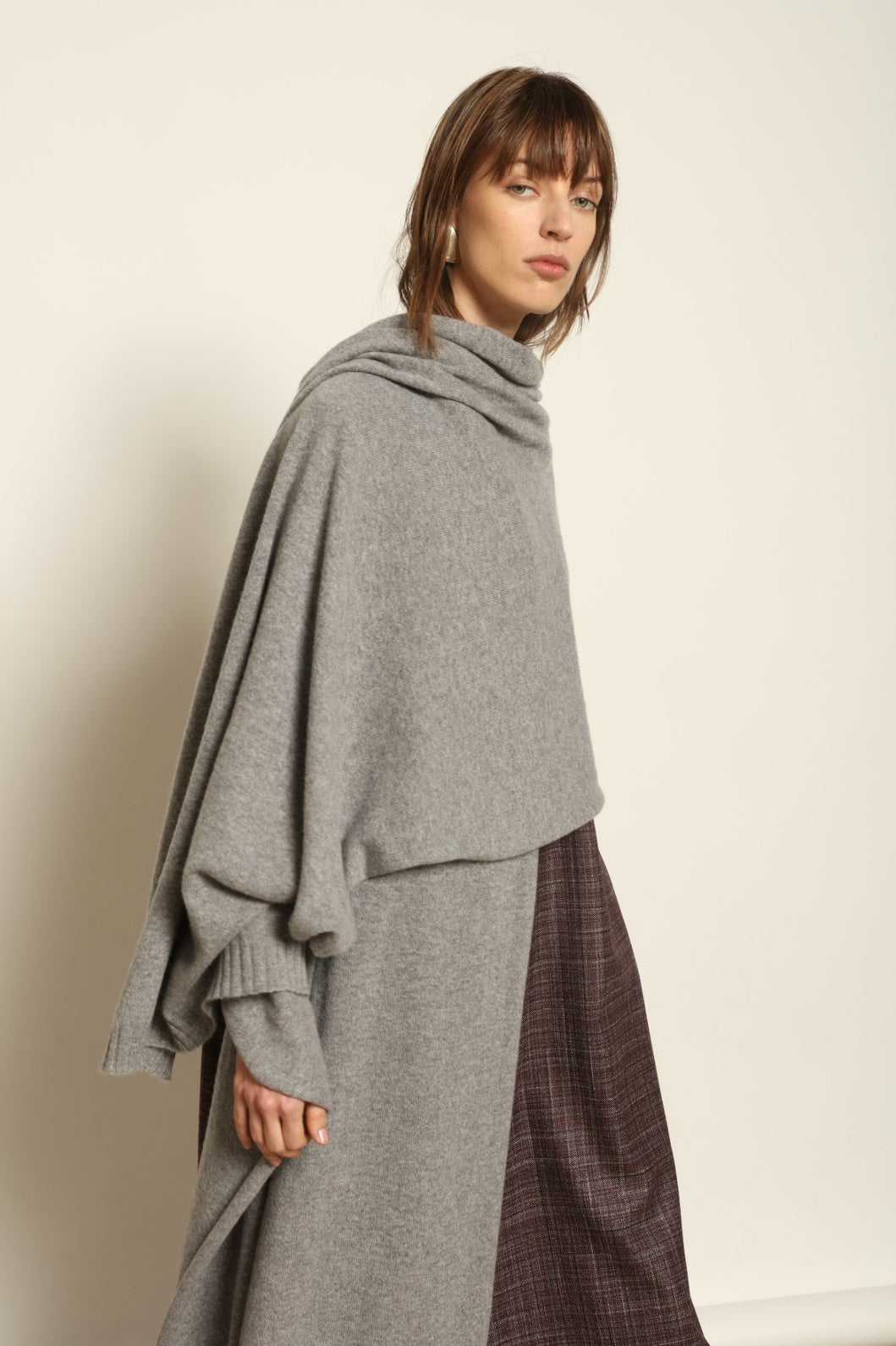 Model wearing the Graphite Leni Cashmere Scarf by House of Woven Stories, made from 100% pure Inner Mongolia cashmere, featuring a soft graphite color, lightweight drape, smooth texture, lasting warmth, and sustainable luxury craftsmanship