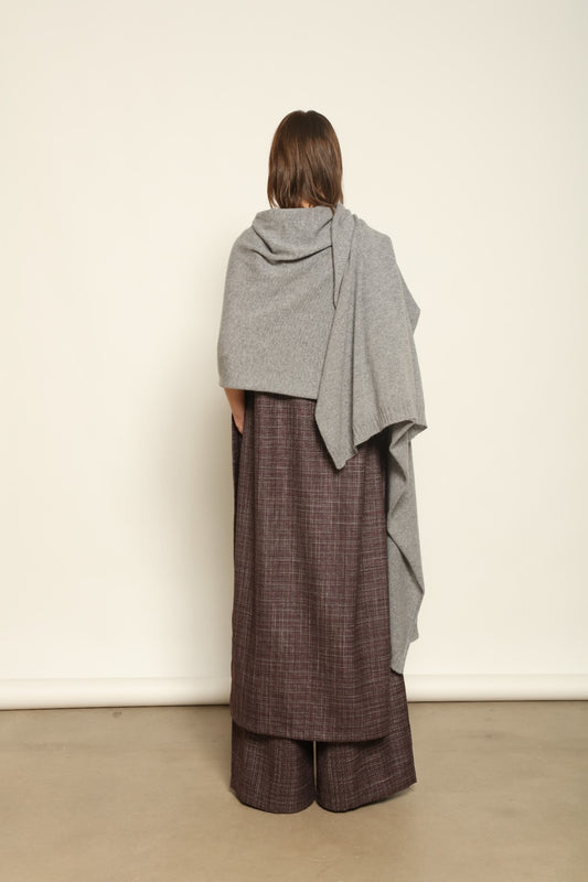 Model wearing the Graphite Leni Cashmere Scarf by House of Woven Stories, made from 100% pure Inner Mongolia cashmere, featuring a soft graphite color, lightweight drape, smooth texture, lasting warmth, and sustainable luxury craftsmanship