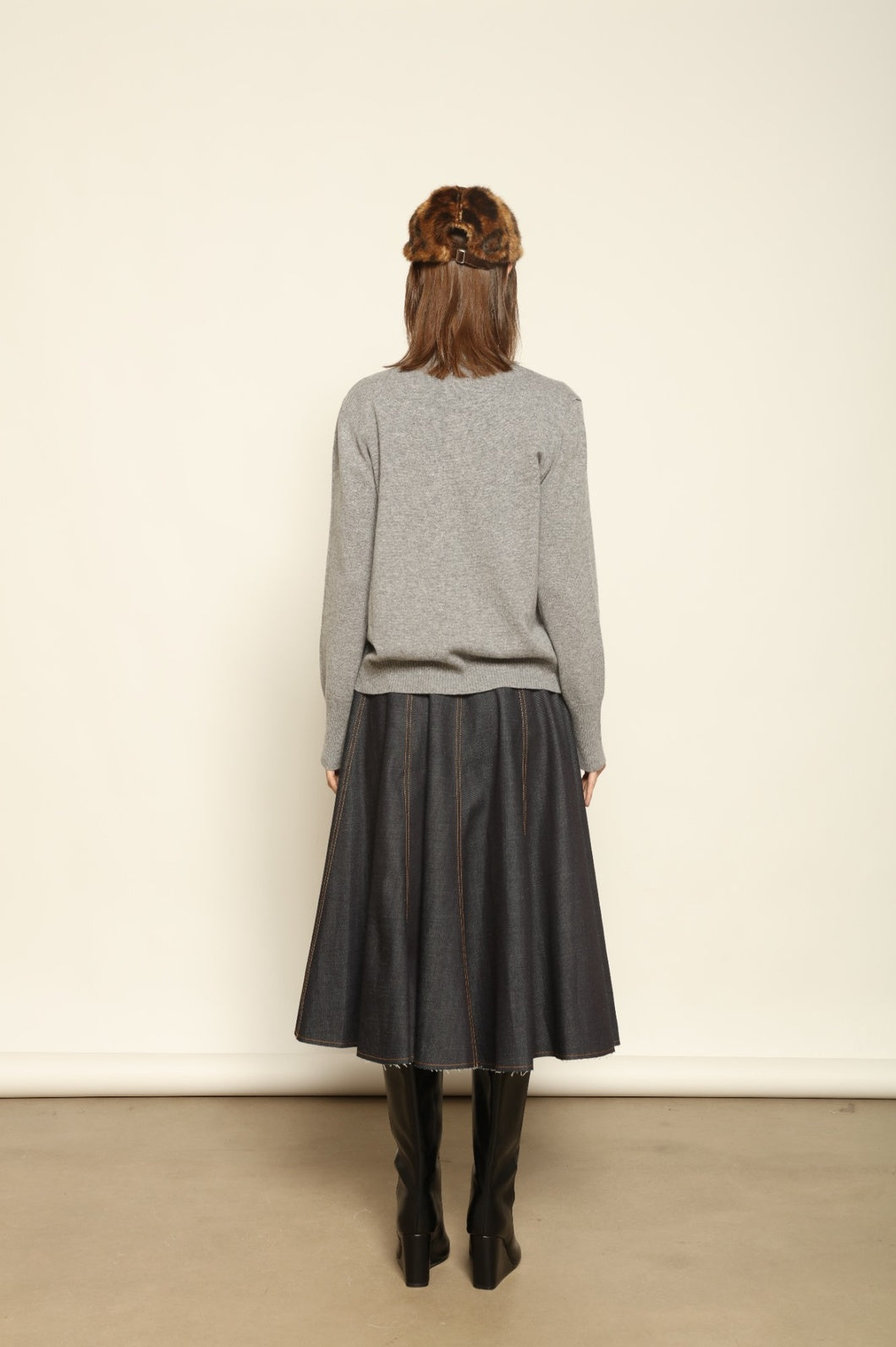 Model wearing the Graphite Nathalie Cashmere Cardigan by House of Woven Stories, made from 100% pure Inner Mongolia cashmere, featuring a deep graphite grey tone, soft breathable texture, open-front silhouette, and sustainable luxury craftsmanship