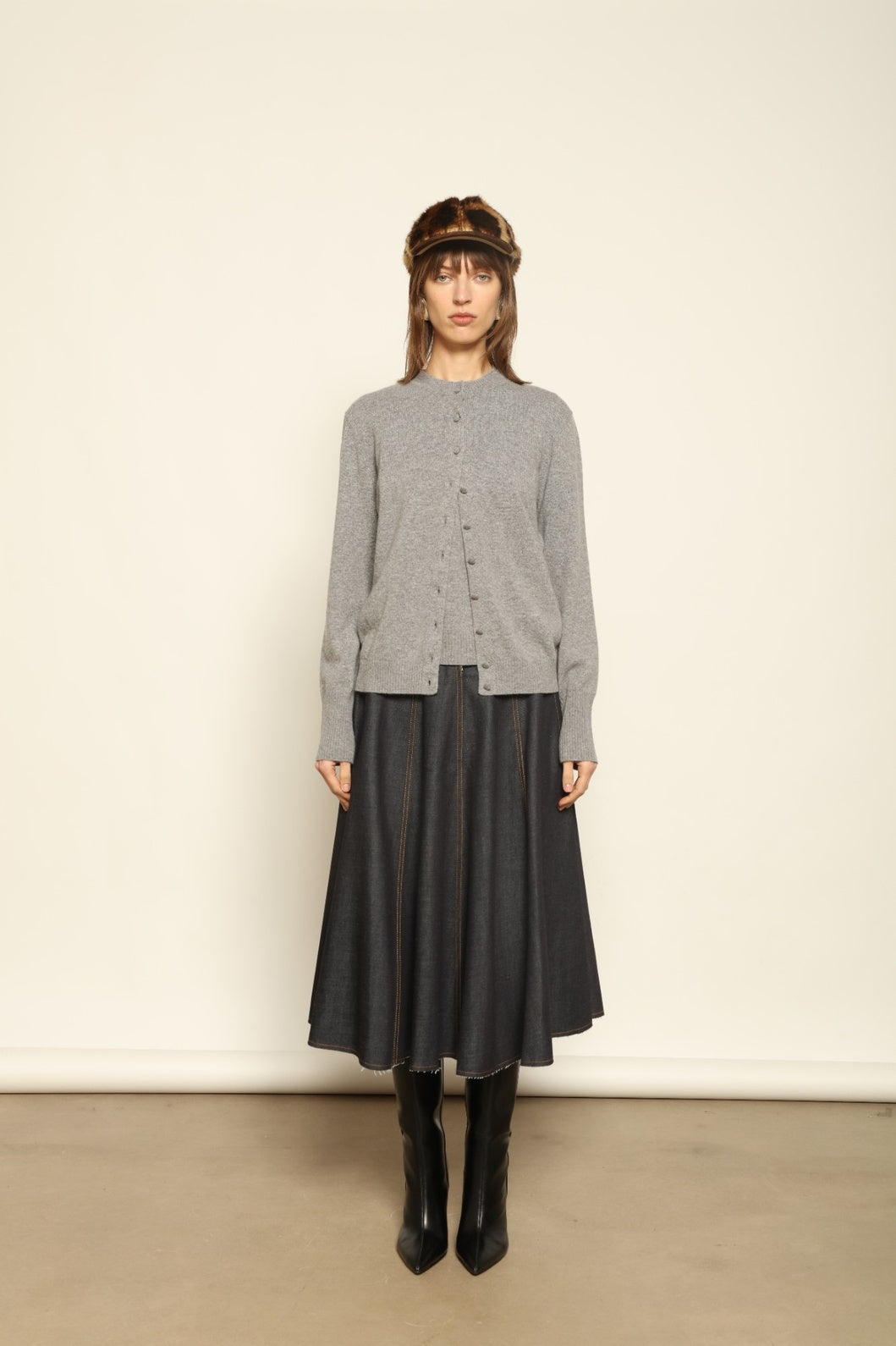 Model wearing the Graphite Nathalie Cashmere Cardigan by House of Woven Stories, made from 100% pure Inner Mongolia cashmere, featuring a deep graphite grey tone, soft breathable texture, open-front silhouette, and sustainable luxury craftsmanship