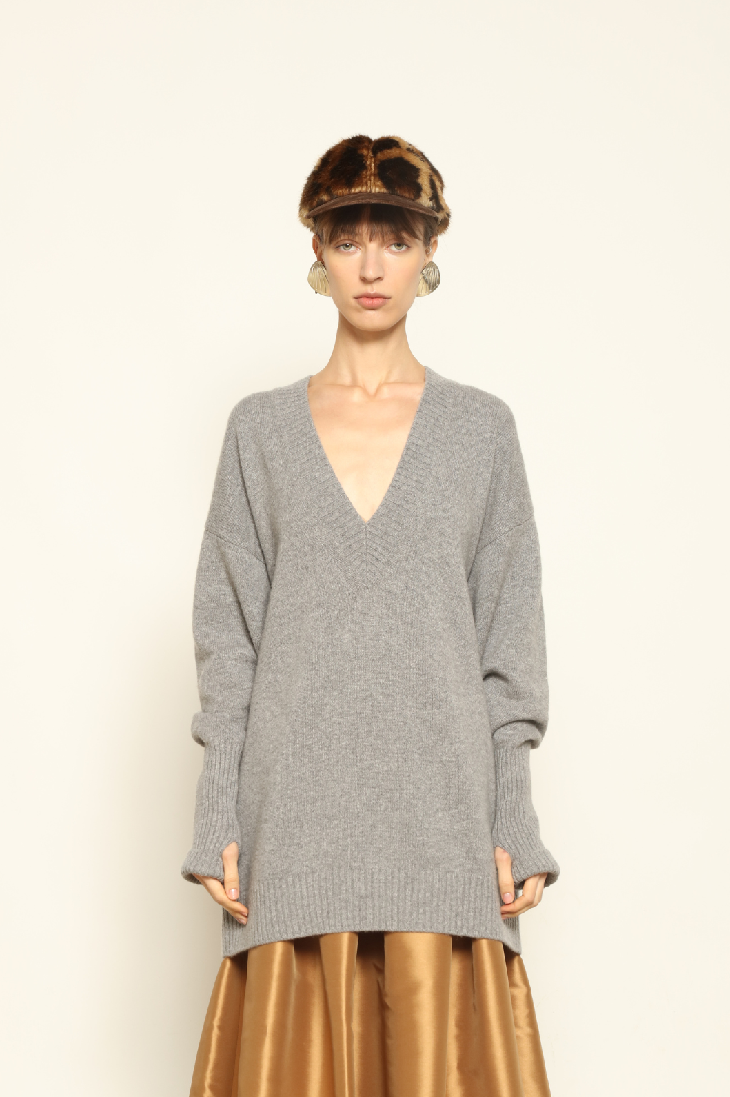 Model wearing the Graphite Nina V-Neck Long Sweater by House of Woven Stories, crafted in Italy from 100% pure Inner Mongolia cashmere, featuring a deep graphite hue, elongated silhouette, soft drape, and timeless sustainable knitwear design