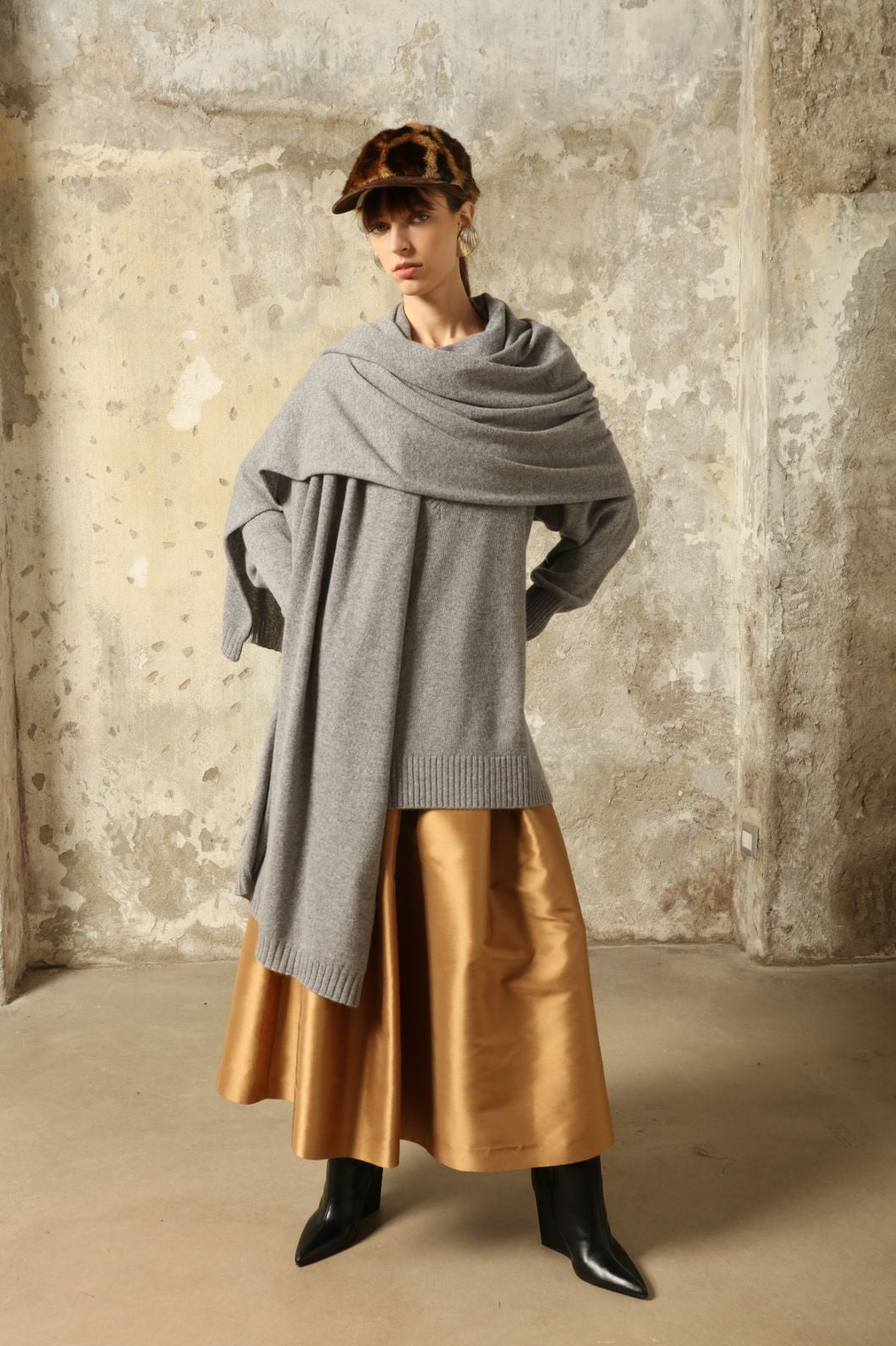 Model wearing the Graphite Nina V-Neck Long Sweater by House of Woven Stories, crafted in Italy from 100% pure Inner Mongolia cashmere, featuring a deep graphite hue, elongated silhouette, soft drape, and timeless sustainable knitwear design