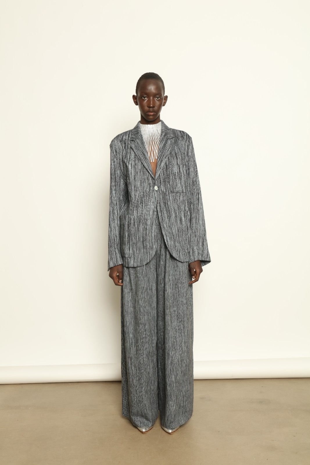 Model is wearing the Grey Chambray Blazer by Marrakshi Life, part of House of Nomad Stories collection, handwoven cotton blazer with relaxed fit, notched collar, and classic tailored details