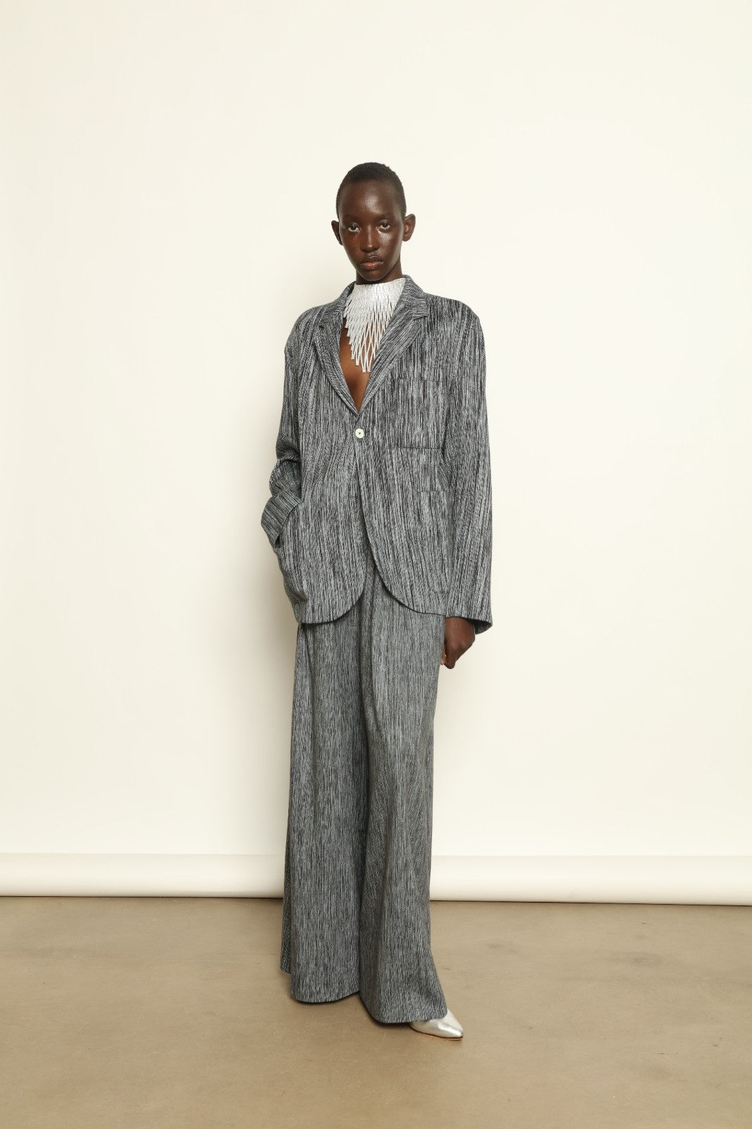 Model is wearing the Grey Chambray Blazer by Marrakshi Life, part of House of Nomad Stories collection, handwoven cotton blazer with relaxed fit, notched collar, and classic tailored details