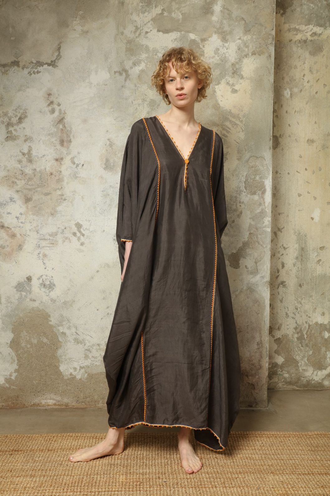 Model is wearing the Thea Grey Silk Dress by Supernaturae x HONS, crafted in handwoven silk from Murshidabad, featuring a relaxed flowing silhouette, elegant open back and natural hand-dyed grey tones. Part of the House of Woven Stories selection
