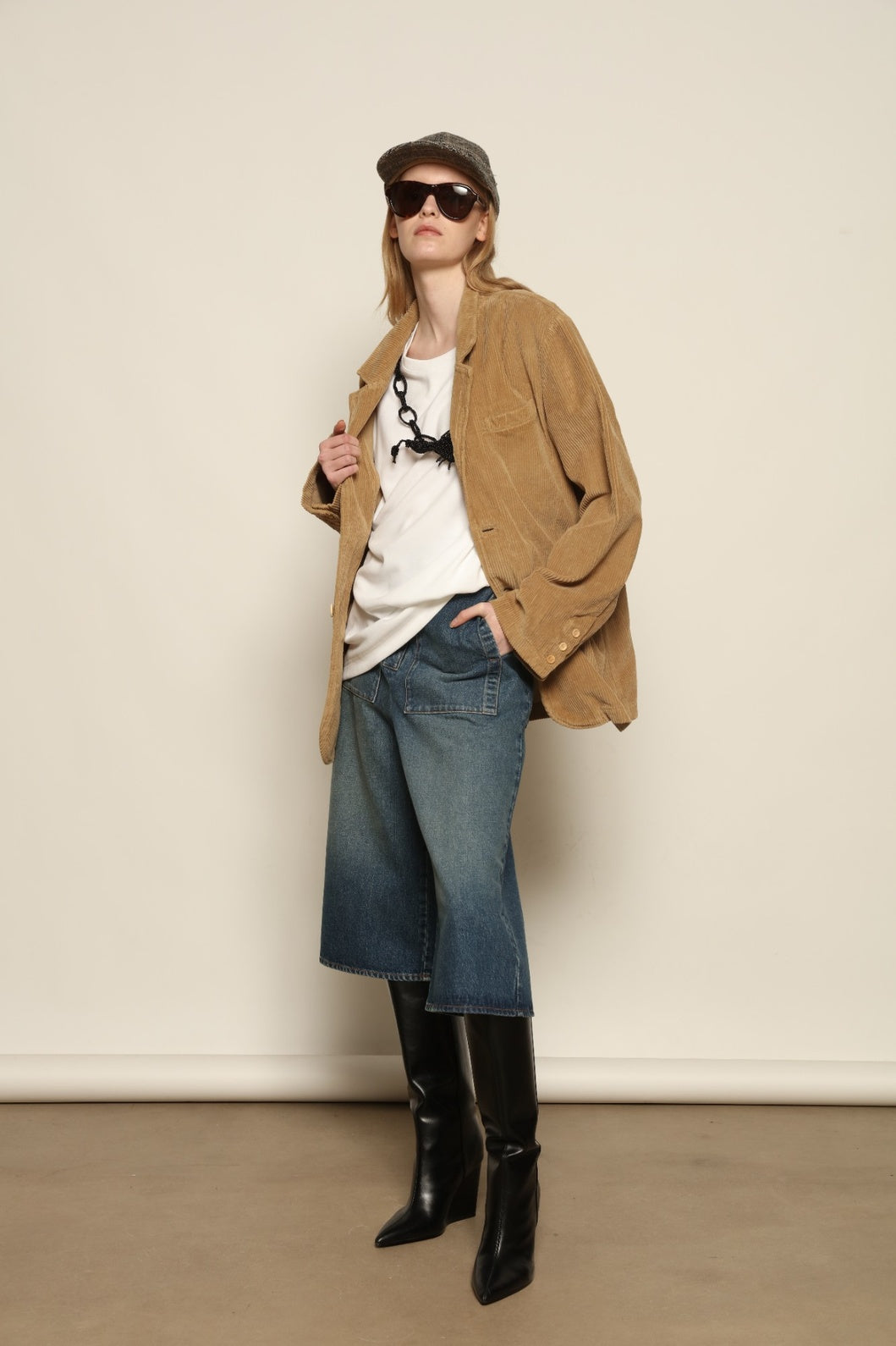 Model is wearing Le Bermuda 4 Poches by Happy Haus, organic denim mid-length bermuda shorts with four oversized patch pockets, curated in the House of Woven Stories selection.