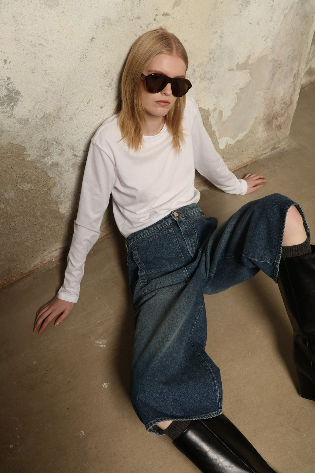 Model is wearing Le Bermuda 4 Poches by Happy Haus, organic denim mid-length bermuda shorts with four oversized patch pockets, curated in the House of Woven Stories selection.