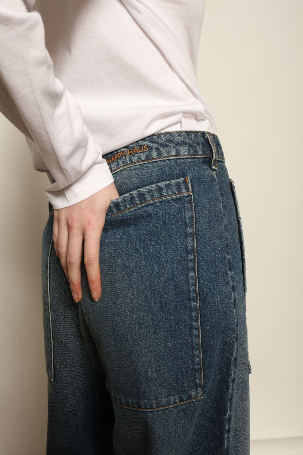 Model is wearing Le Bermuda 4 Poches by Happy Haus, organic denim mid-length bermuda shorts with four oversized patch pockets, curated in the House of Woven Stories selection.