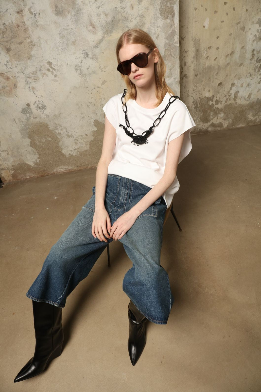 Model is wearing Le Bermuda 4 Poches by Happy Haus, organic denim mid-length bermuda shorts with four oversized patch pockets, curated in the House of Woven Stories selection.