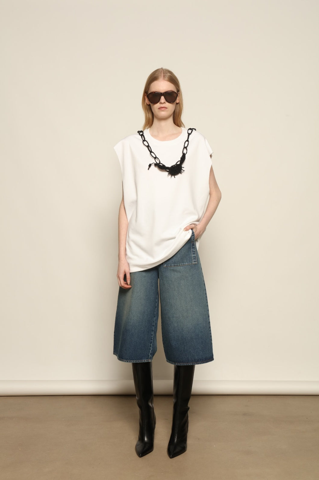 Model is wearing Le Bermuda 4 Poches by Happy Haus, organic denim mid-length bermuda shorts with four oversized patch pockets, curated in the House of Woven Stories selection.