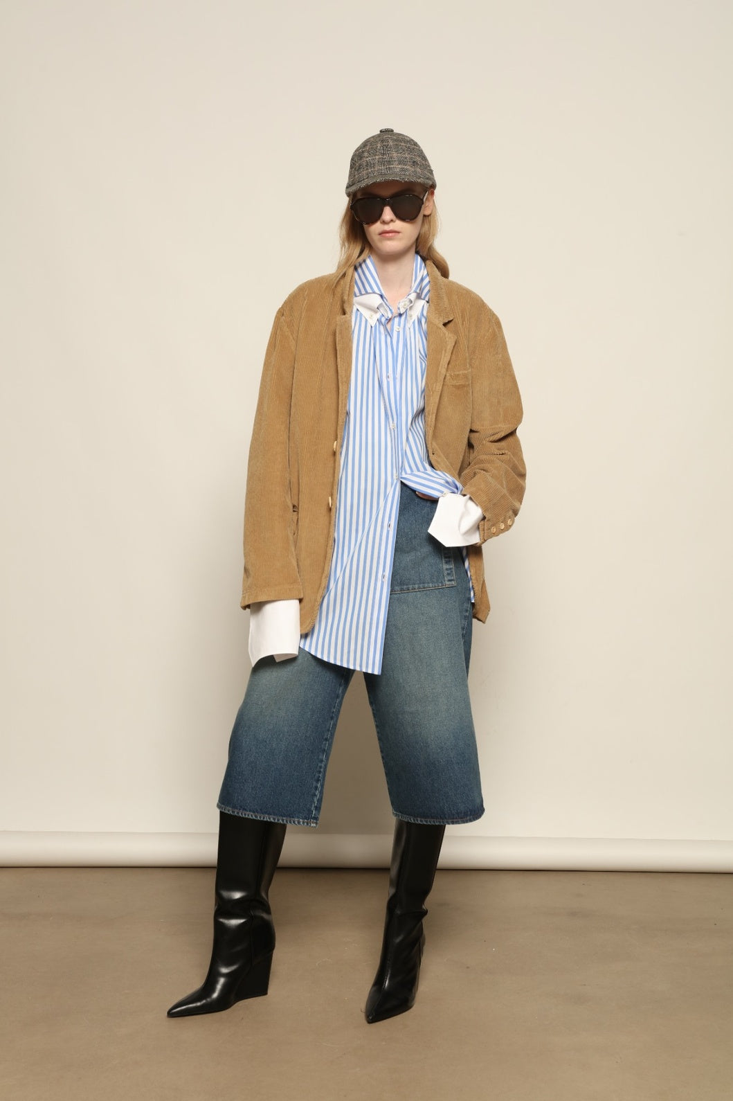 Model is wearing Le Blazer in Vintage Beige by Happy Haus, a GOTS-certified Italian corduroy cotton tailored jacket with relaxed straight silhouette, flap pockets, wooden buttons and soft back slit, curated in the House of Woven Stories selection.