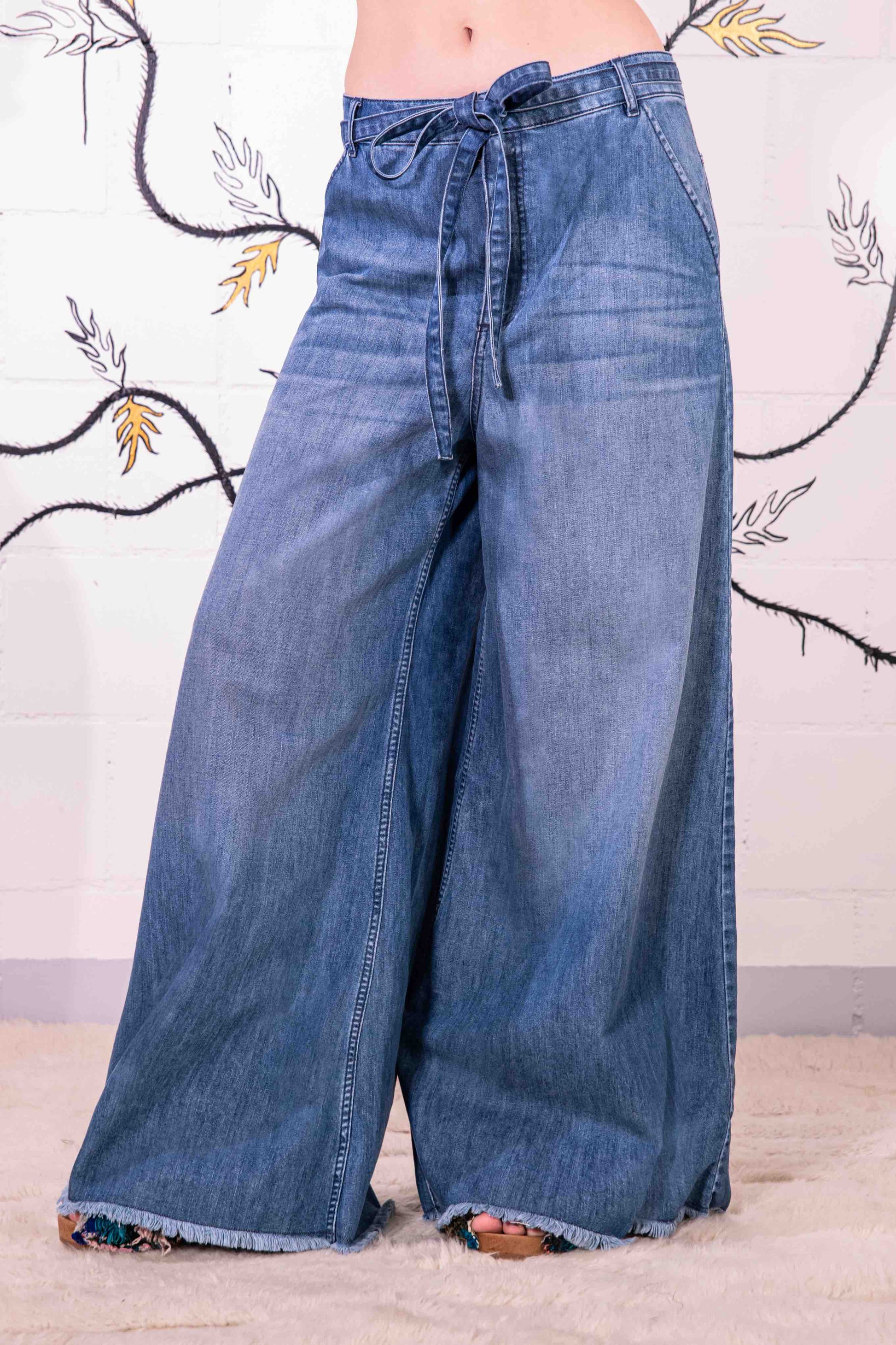Model is wearing relaxed, flared-fit jeans by Happy Haus, crafted in Italy from 100% DETOX-certified cotton. A sustainable essential from the House of Woven Stories collection, designed for timeless, conscious style.