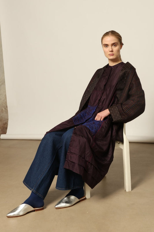 Model is wearing the Harmony Kantha Jacket by Obidi, made from reused sari fabric with traditional kantha hand-stitching, combining heritage craftsmanship with a contemporary silhouette.