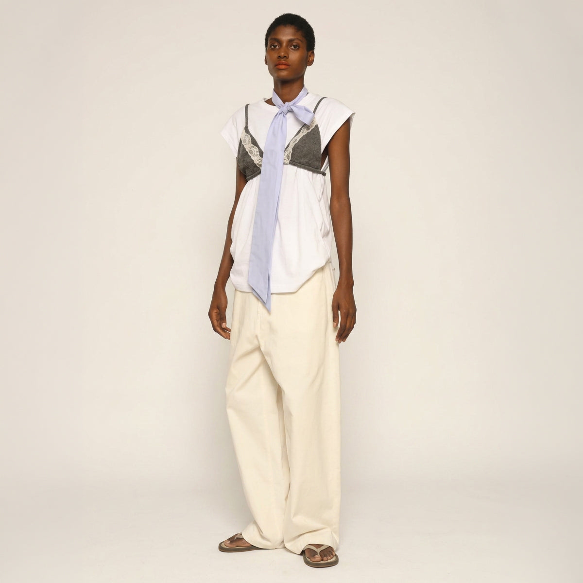 Model is wearing the Carla Cotton Pant by Maison Jejia from House of Nomad Stories, white organic cotton wide-leg trousers with a relaxed silhouette and four pockets.