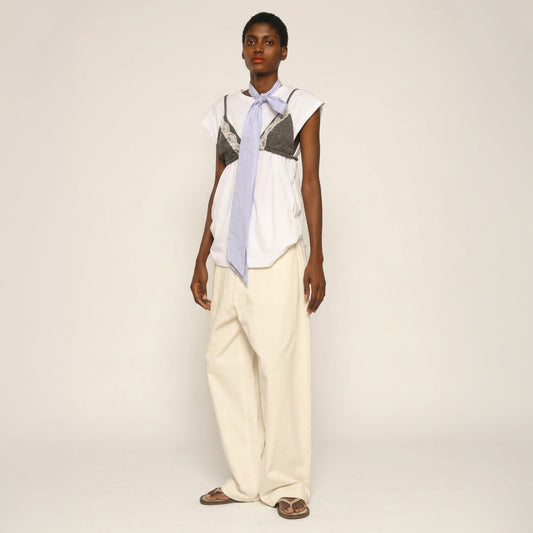 Model is wearing the Carla Cotton Pant by Maison Jejia from House of Nomad Stories, white organic cotton wide-leg trousers with a relaxed silhouette and four pockets.