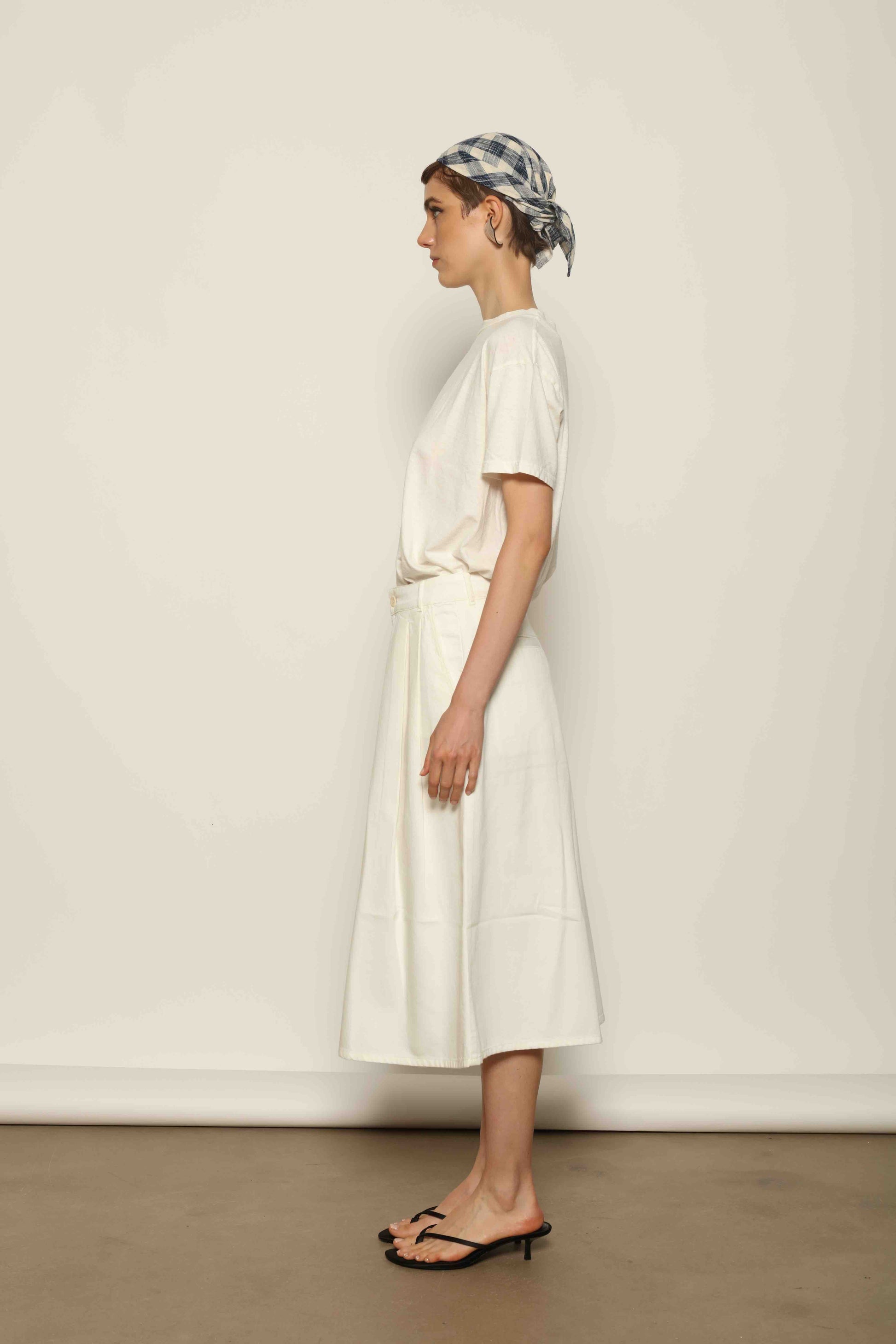 Model wearing the La Jupe Culotte in Blanc Cassè by Happy Haus from the House of Nomad Stories collection, featuring premium Japanese denim, a high-waisted fit, wide-leg silhouette, and elegant ankle-length design.