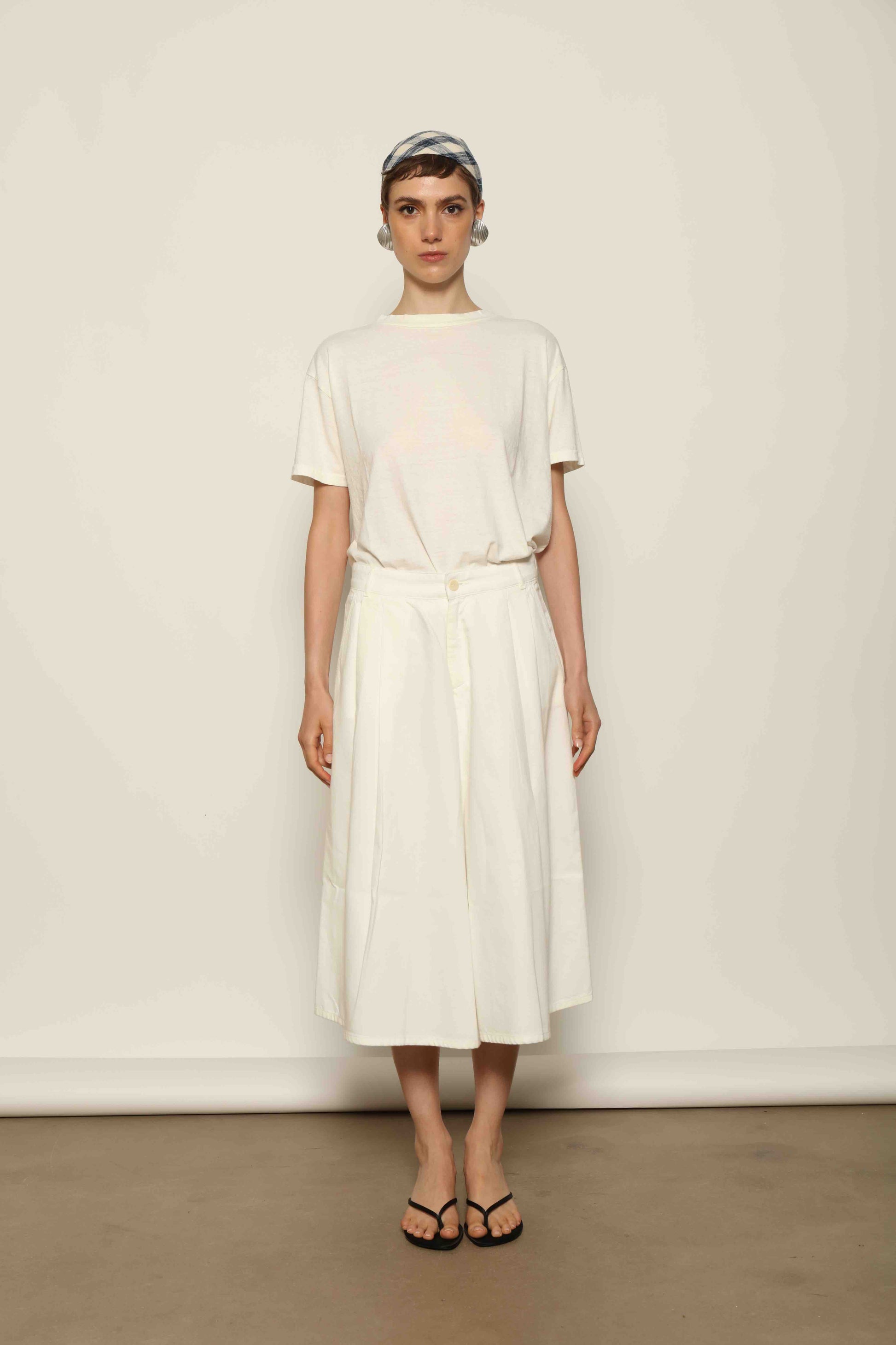 Model wearing the La Jupe Culotte in Blanc Cassè by Happy Haus from the House of Nomad Stories collection, featuring premium Japanese denim, a high-waisted fit, wide-leg silhouette, and elegant ankle-length design.