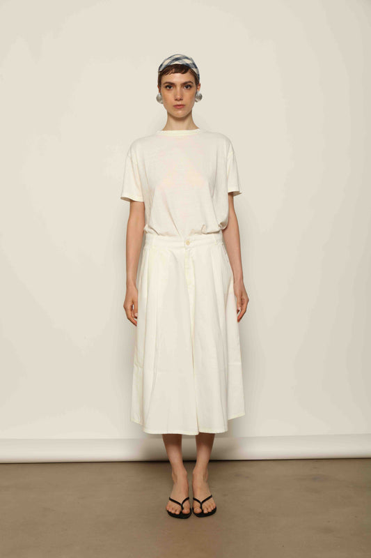 Model wearing the La Jupe Culotte in Blanc Cassè by Happy Haus from the House of Nomad Stories collection, featuring premium Japanese denim, a high-waisted fit, wide-leg silhouette, and elegant ankle-length design.