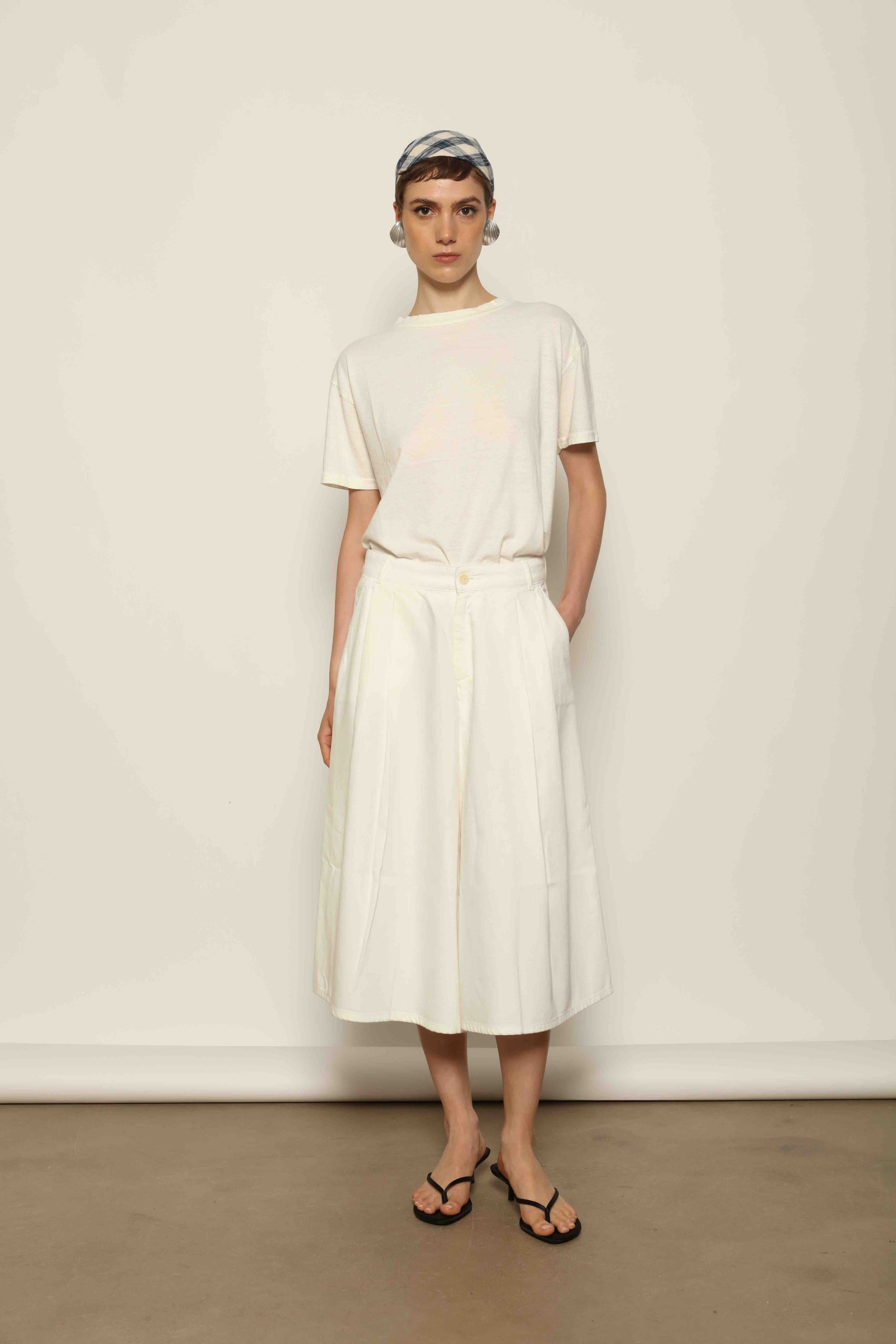 Model wearing the La Jupe Culotte in Blanc Cassè by Happy Haus from the House of Nomad Stories collection, featuring premium Japanese denim, a high-waisted fit, wide-leg silhouette, and elegant ankle-length design.