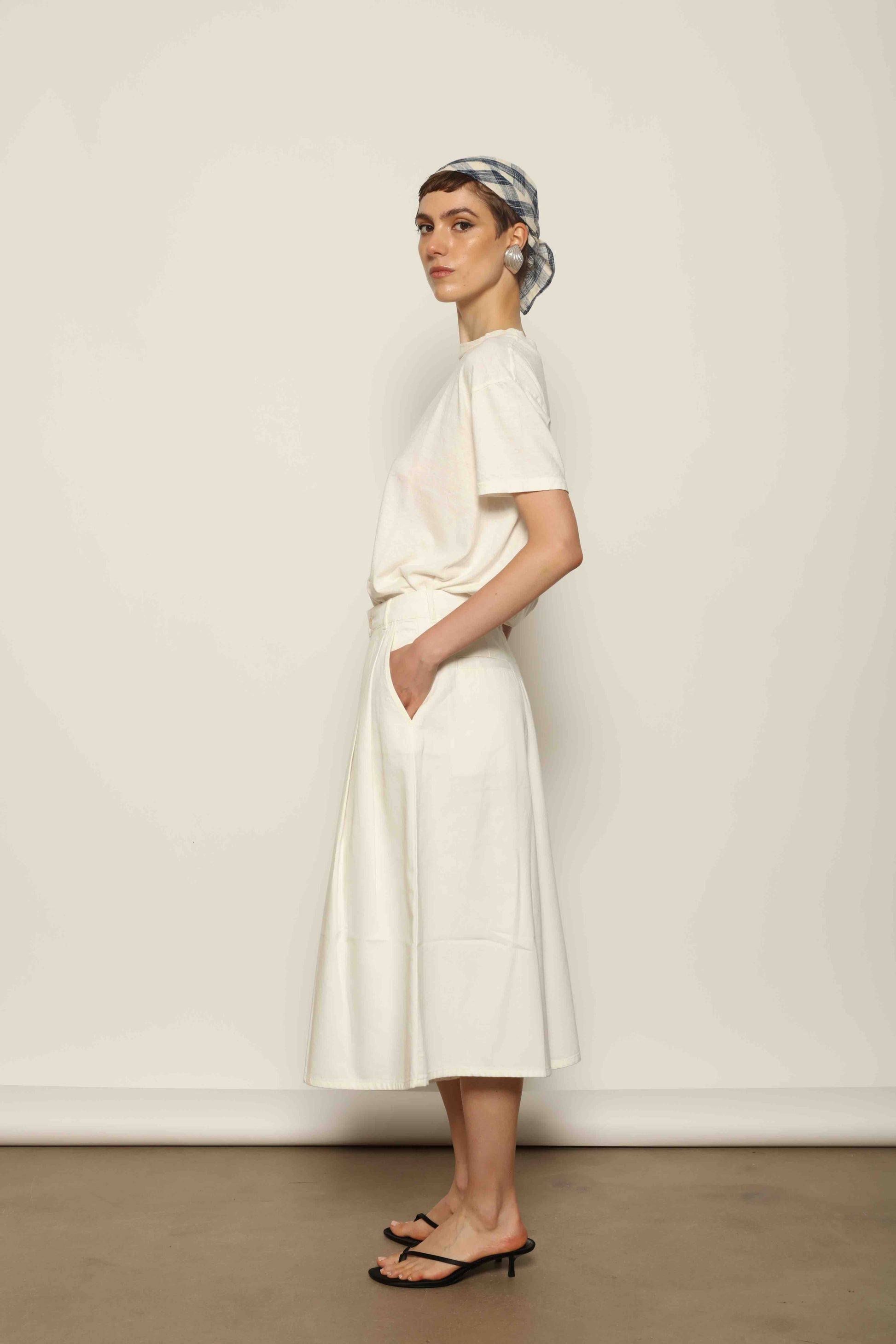 Model wearing the La Jupe Culotte in Blanc Cassè by Happy Haus from the House of Nomad Stories collection, featuring premium Japanese denim, a high-waisted fit, wide-leg silhouette, and elegant ankle-length design.