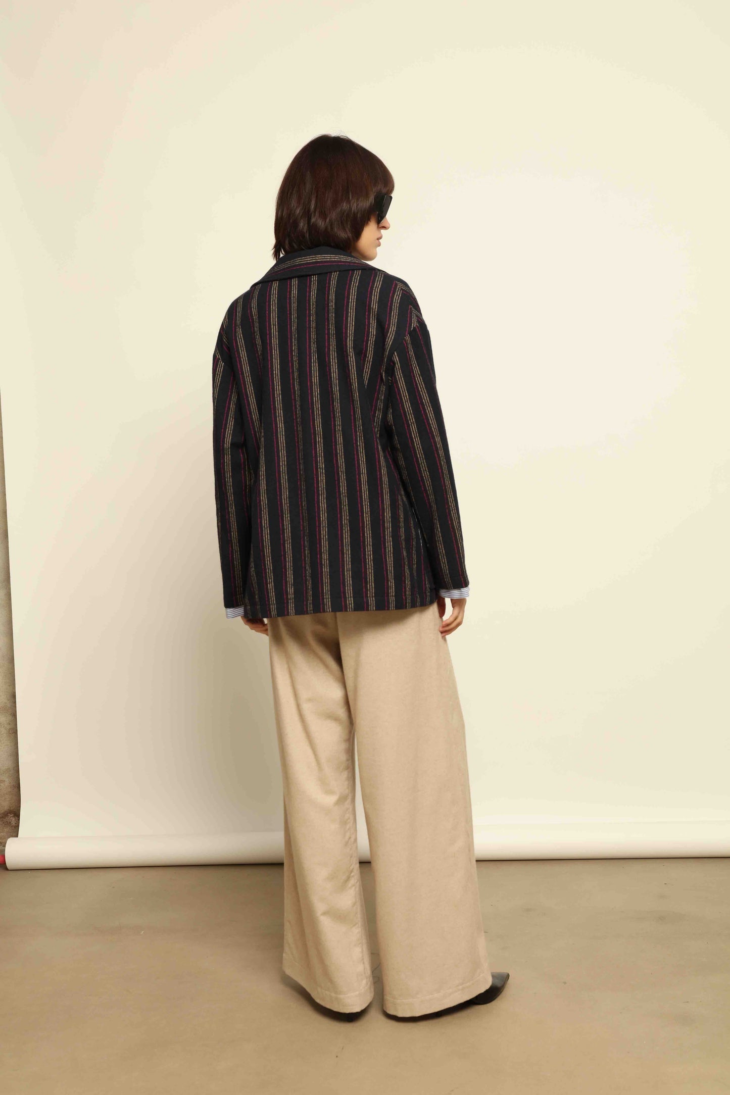 Model is wearing the Navy Blue Striped Double-Breasted Blazer by Balia 8.22, crafted in Italy from virgin wool and cotton with a structured silhouette for timeless elegance.