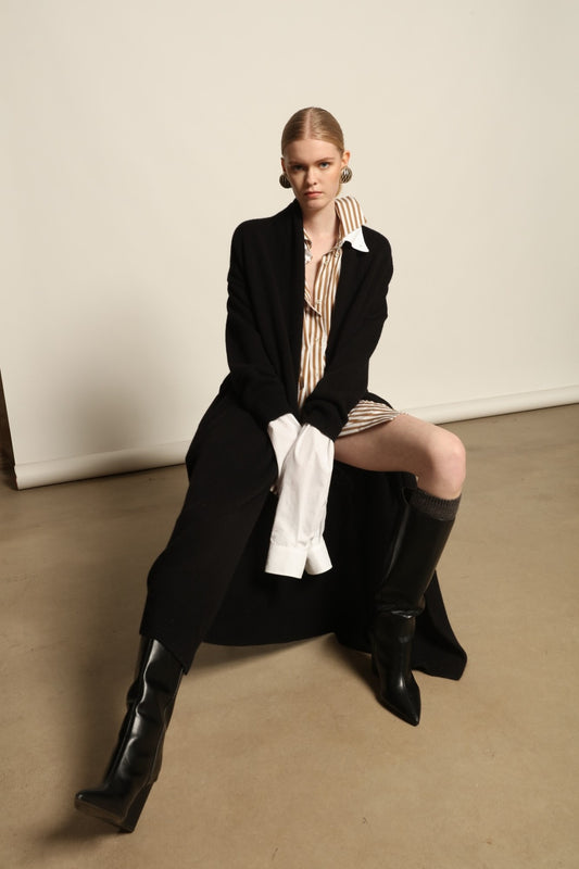 Model is wearing the Black Paula Cashmere Coat by House of Woven Stories, a pure ethically sourced cashmere coat in deep black with fluid open-front silhouette and refined drape.