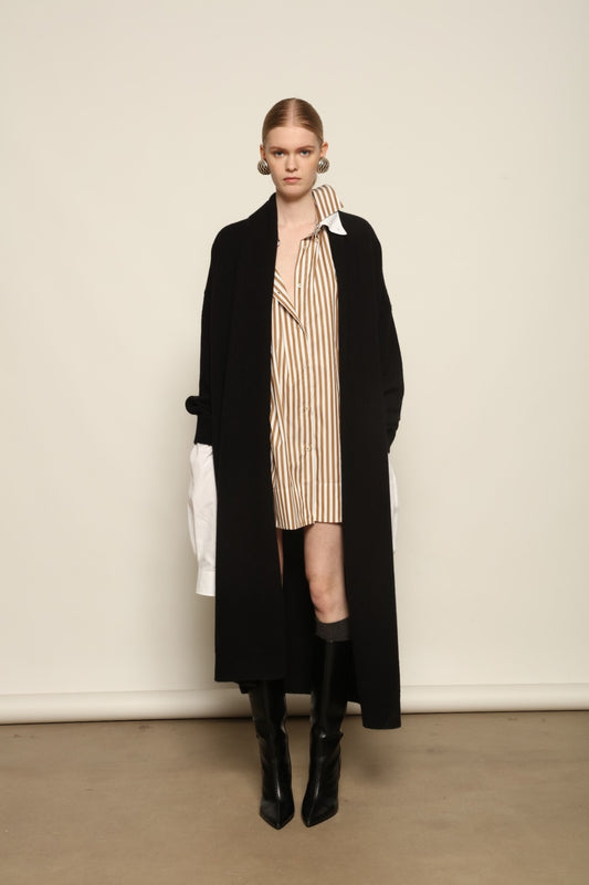 Model is wearing the Black Paula Cashmere Coat by House of Woven Stories, a pure ethically sourced cashmere coat in deep black with fluid open-front silhouette and refined drape.