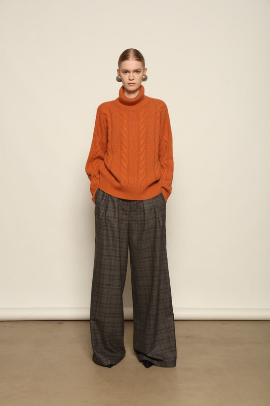 Model is wearing the Brown Check Parigi Pants by House of Woven Stories, relaxed straight-leg Merino wool trousers with a soft brown check pattern, handcrafted in Italy.