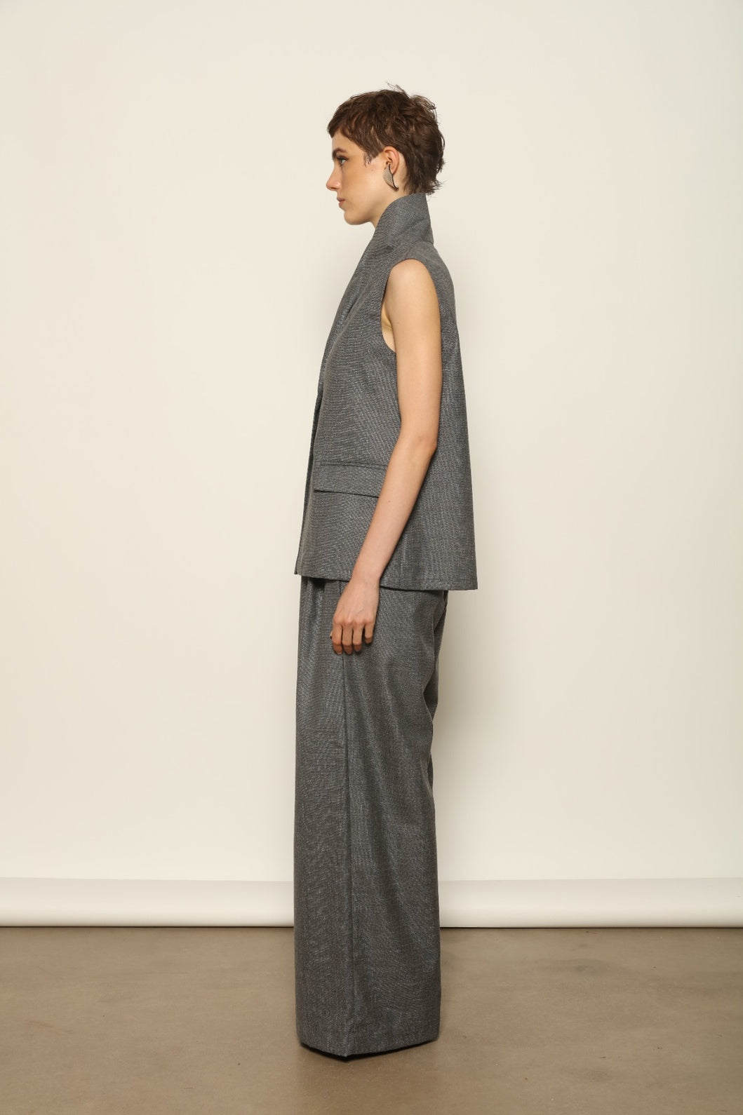 Model wearing the Franca Grey Off White Gilet by House of Woven Stories, featuring a tailored structured silhouette, clean minimalist design, and refined layered styling in a grey off-white tone.