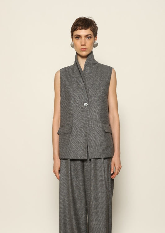 Model wearing the Franca Grey Off White Gilet by House of Woven Stories, featuring a tailored structured silhouette, clean minimalist design, and refined layered styling in a grey off-white tone.