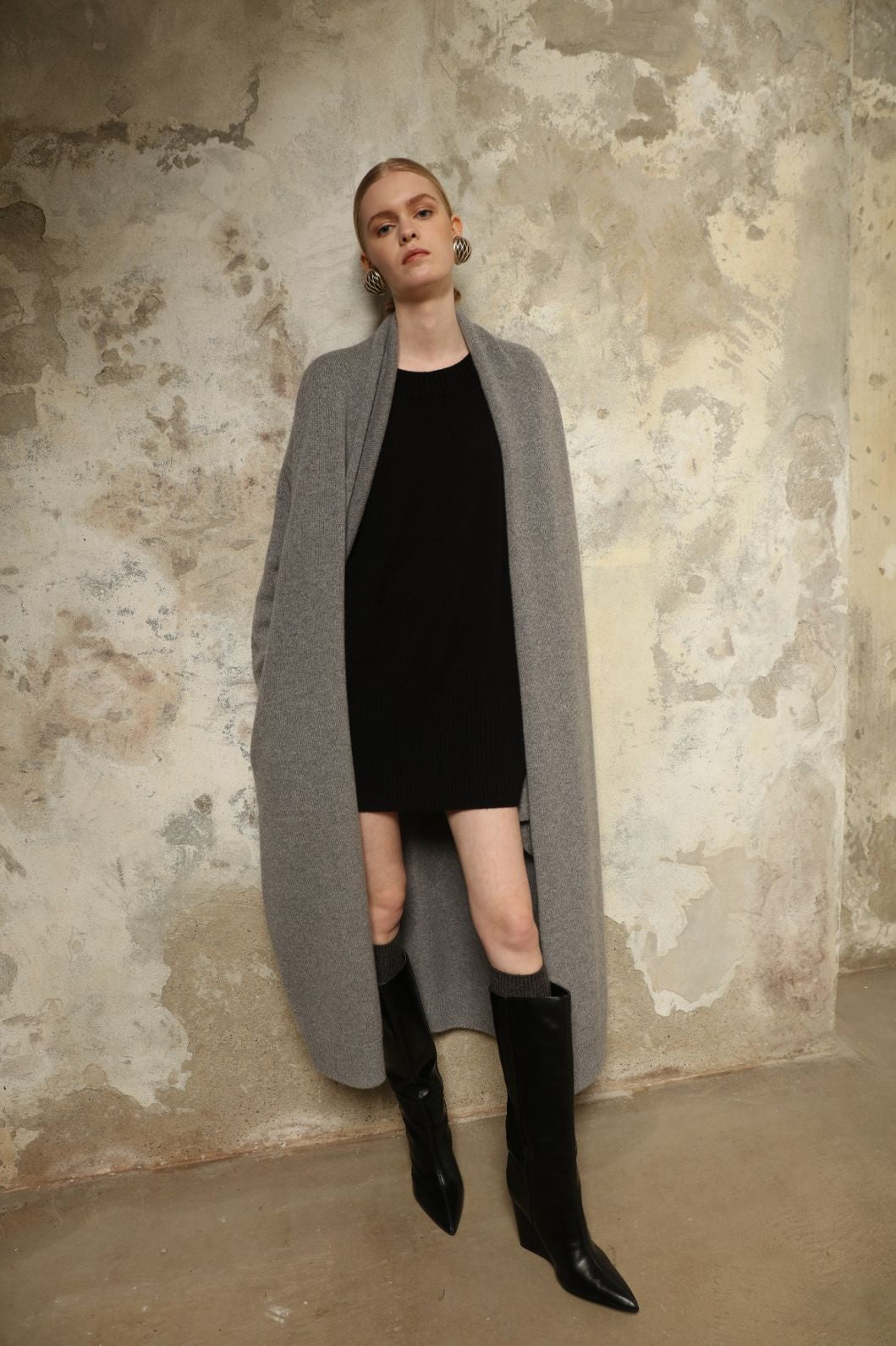 Model is wearing the Graphite Paula Cashmere Coat by House of Woven Stories, a pure ethically sourced cashmere coat in deep graphite with fluid open-front silhouette and refined soft drape.
