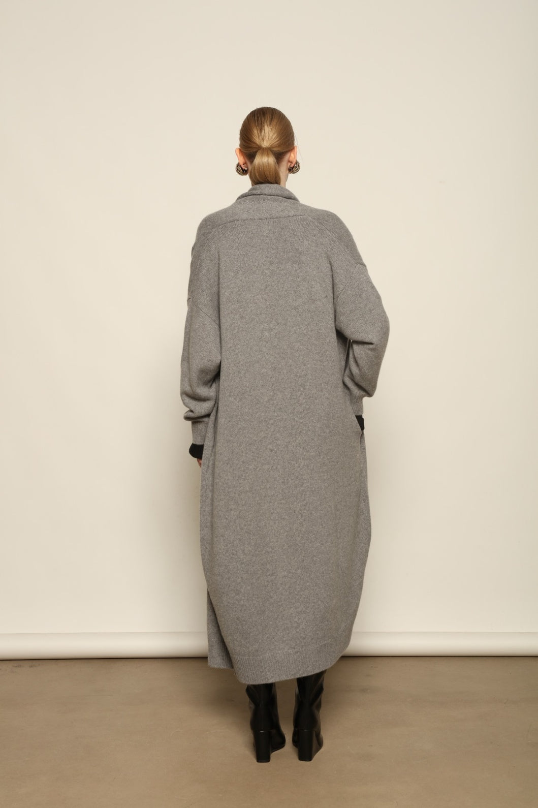 Model is wearing the Graphite Paula Cashmere Coat by House of Woven Stories, a pure ethically sourced cashmere coat in deep graphite with fluid open-front silhouette and refined soft drape.