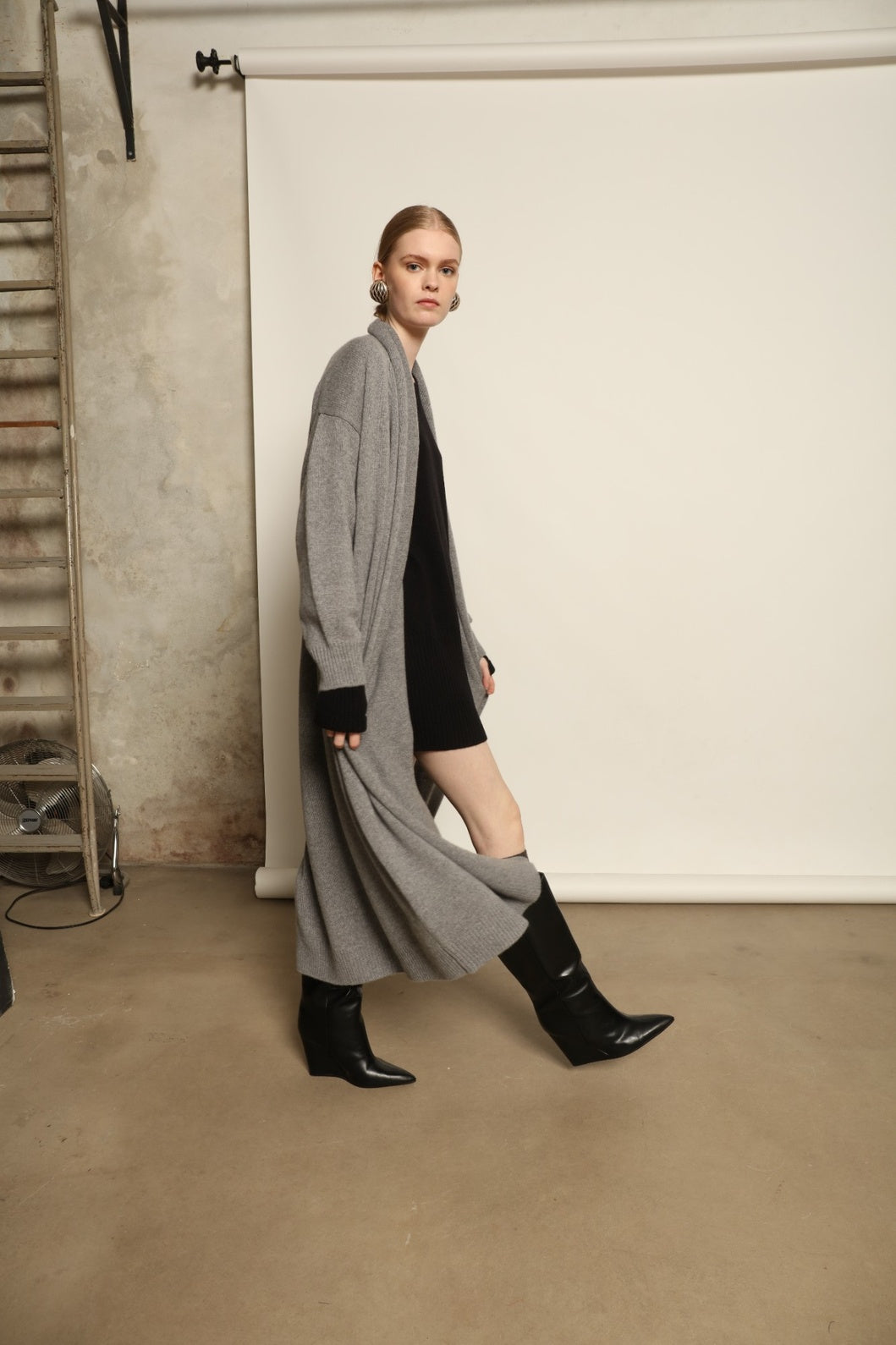 Model is wearing the Graphite Paula Cashmere Coat by House of Woven Stories, a pure ethically sourced cashmere coat in deep graphite with fluid open-front silhouette and refined soft drape.