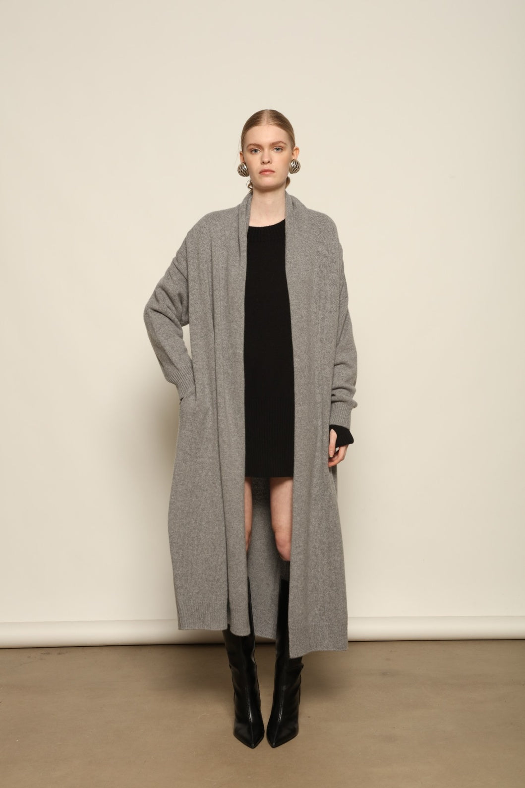 Model is wearing the Graphite Paula Cashmere Coat by House of Woven Stories, a pure ethically sourced cashmere coat in deep graphite with fluid open-front silhouette and refined soft drape.