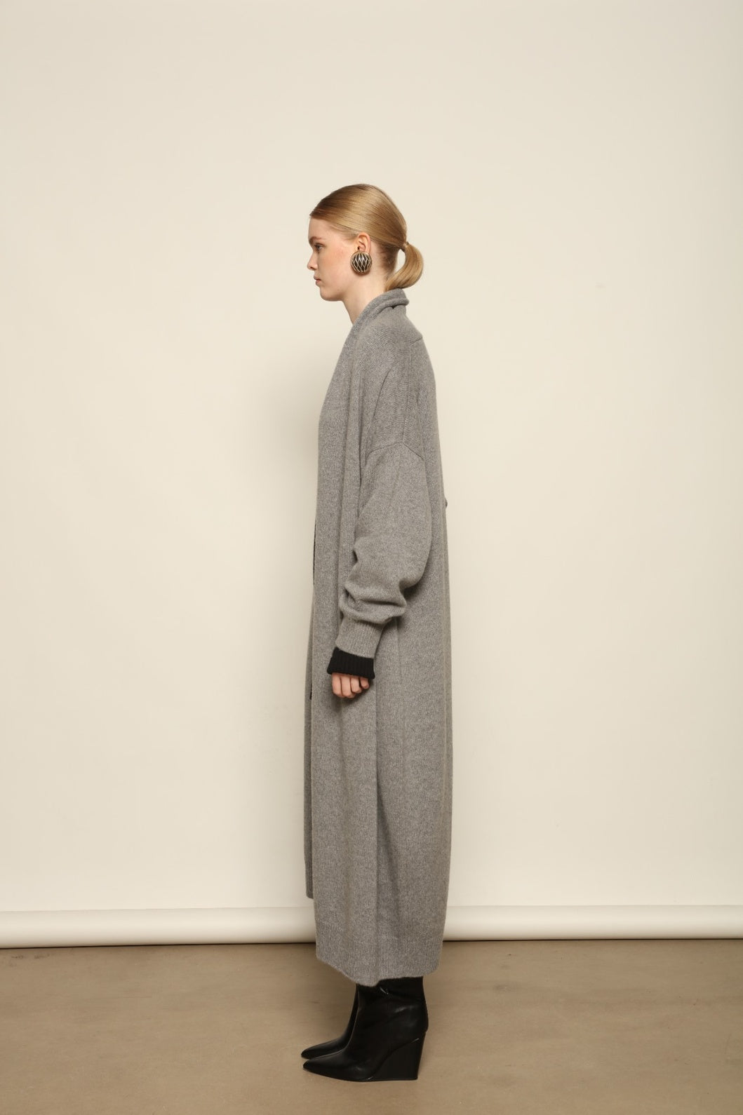 Model is wearing the Graphite Paula Cashmere Coat by House of Woven Stories, a pure ethically sourced cashmere coat in deep graphite with fluid open-front silhouette and refined soft drape.