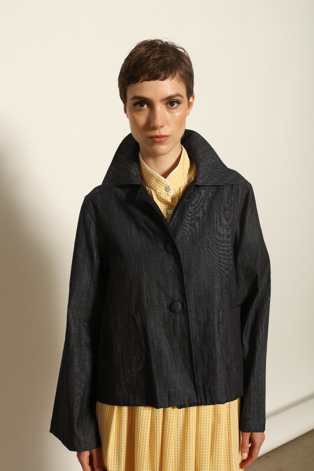 Model wearing the Katharina Ink Denim Jacket by House of Woven Stories, featuring rich ink-toned denim, relaxed structured silhouette, and refined tailored detailing in premium cotton.