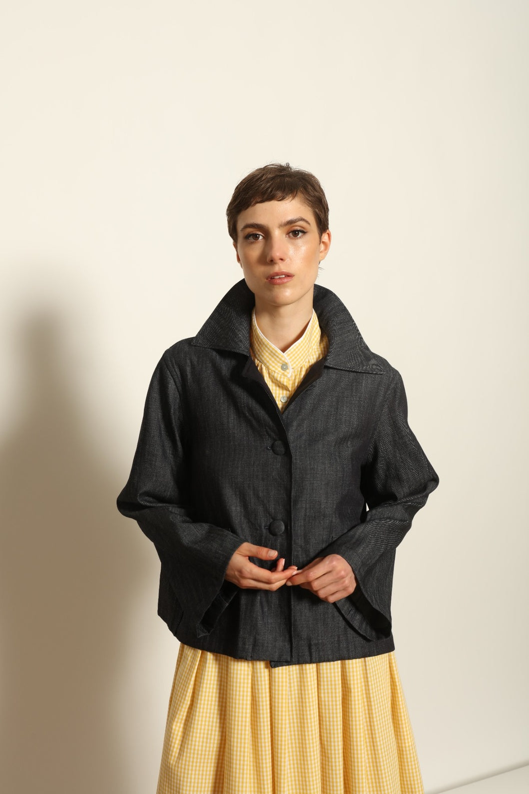 Model wearing the Katharina Ink Denim Jacket by House of Woven Stories, featuring rich ink-toned denim, relaxed structured silhouette, and refined tailored detailing in premium cotton.