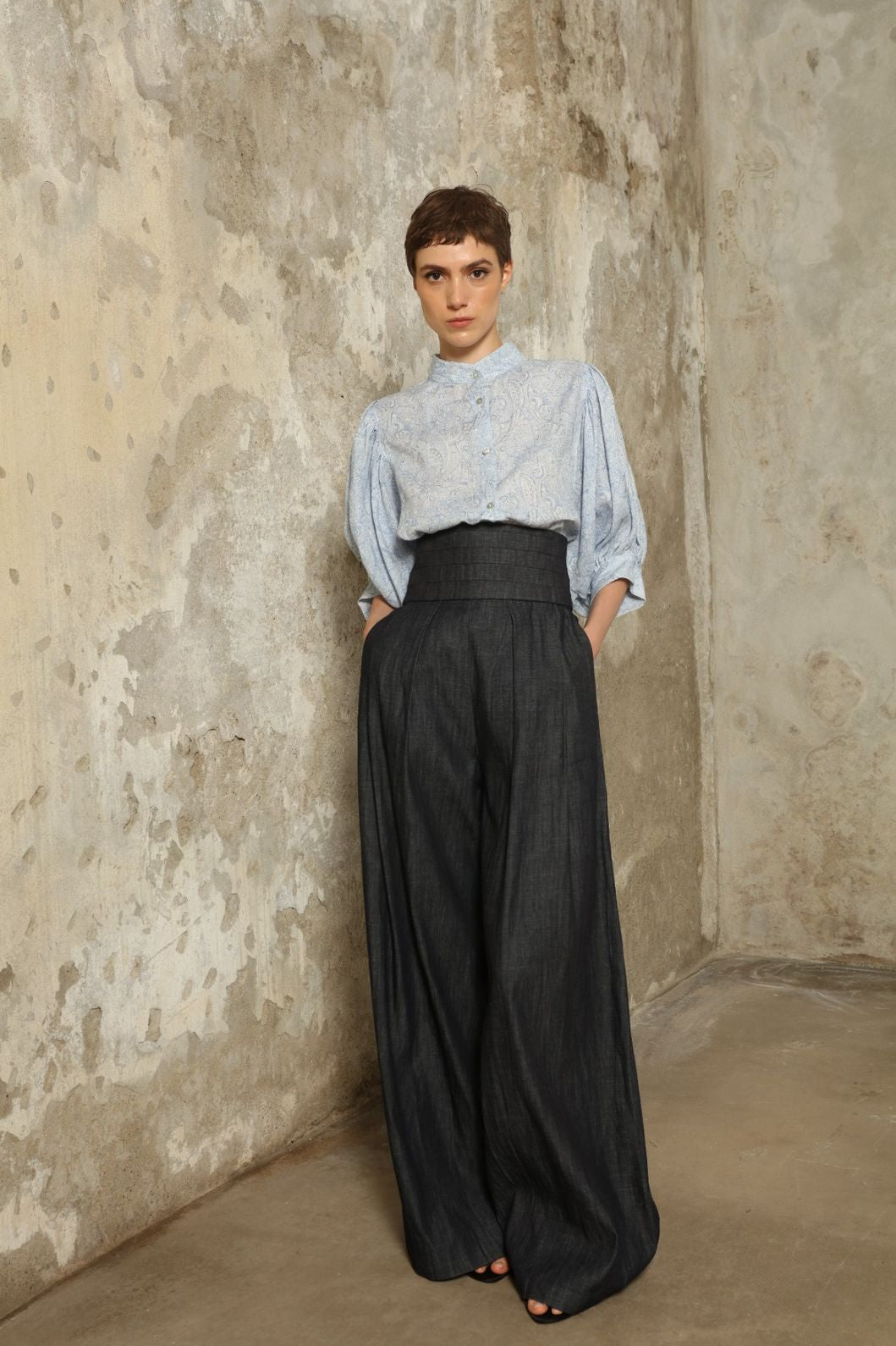 Model wearing the Lola Paisley Blouse by House of Woven Stories, featuring 100% linen fabric, delicate paisley print, relaxed silhouette, and lightweight breathable summer design.