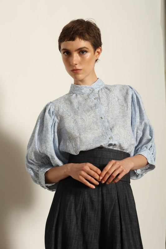 Model wearing the Lola Paisley Blouse by House of Woven Stories, featuring 100% linen fabric, delicate paisley print, relaxed silhouette, and lightweight breathable summer design.