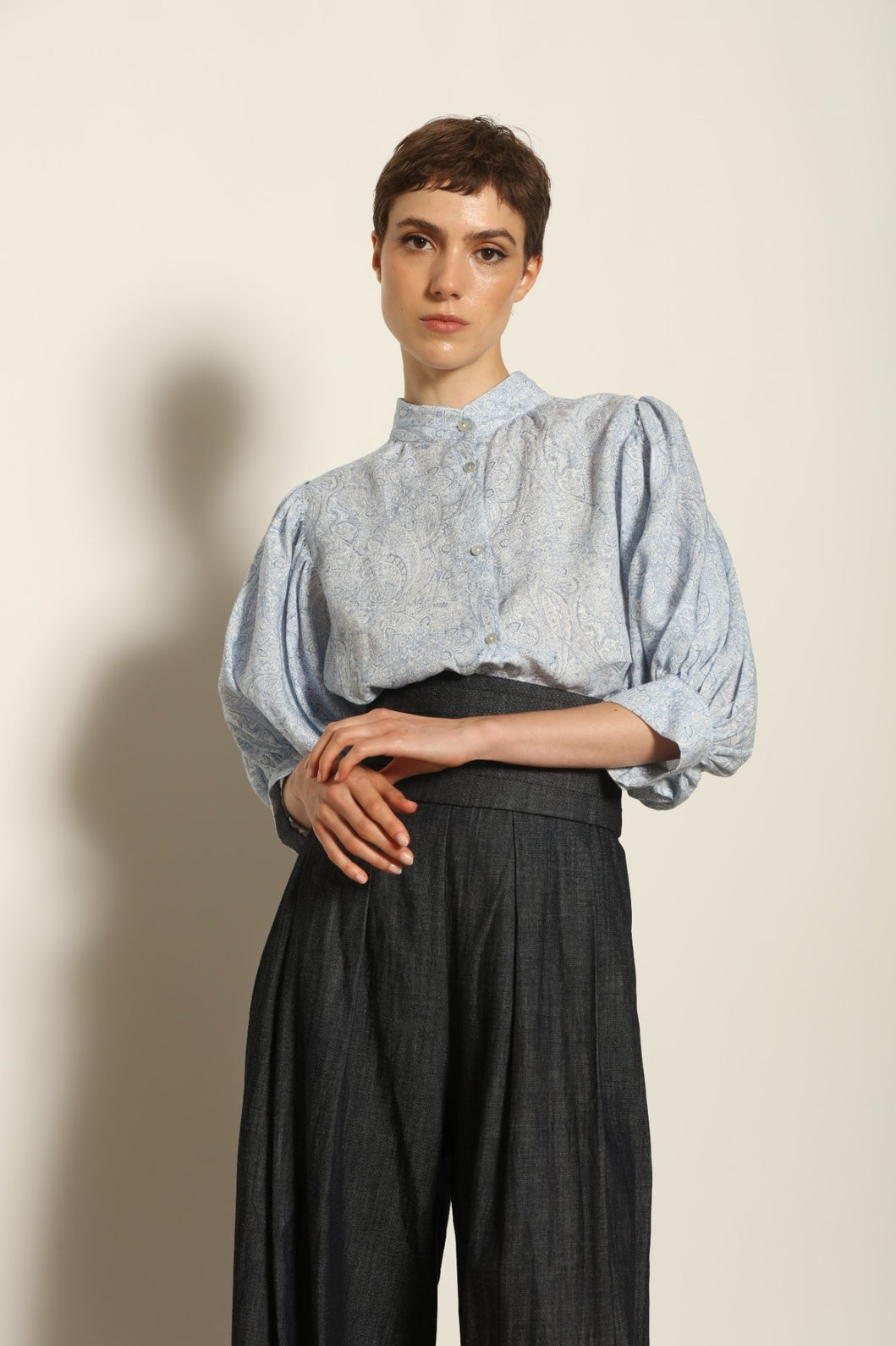 Model wearing the Lola Paisley Blouse by House of Woven Stories, featuring 100% linen fabric, delicate paisley print, relaxed silhouette, and lightweight breathable summer design.