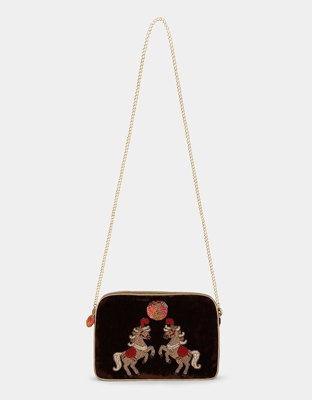 Olivia Dar Horse Brown Velvet Sling Bag by House of Woven Stories, featuring two rearing horses hand-embroidered with beads and threads in red, gold and white, with a removable chain strap for shoulder or crossbody wear.