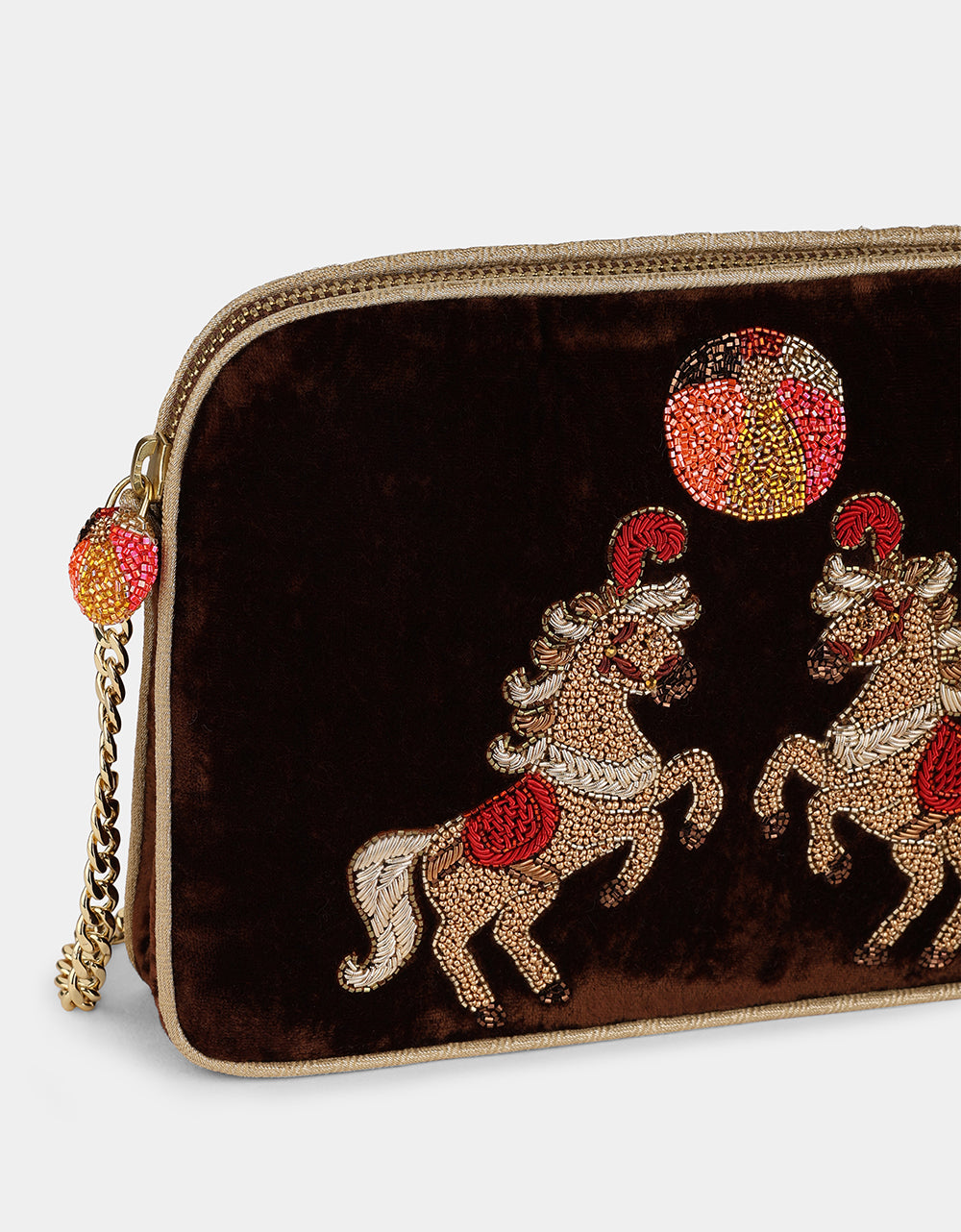 Olivia Dar Horse Brown Velvet Sling Bag by House of Woven Stories, featuring two rearing horses hand-embroidered with beads and threads in red, gold and white, with a removable chain strap for shoulder or crossbody wear.