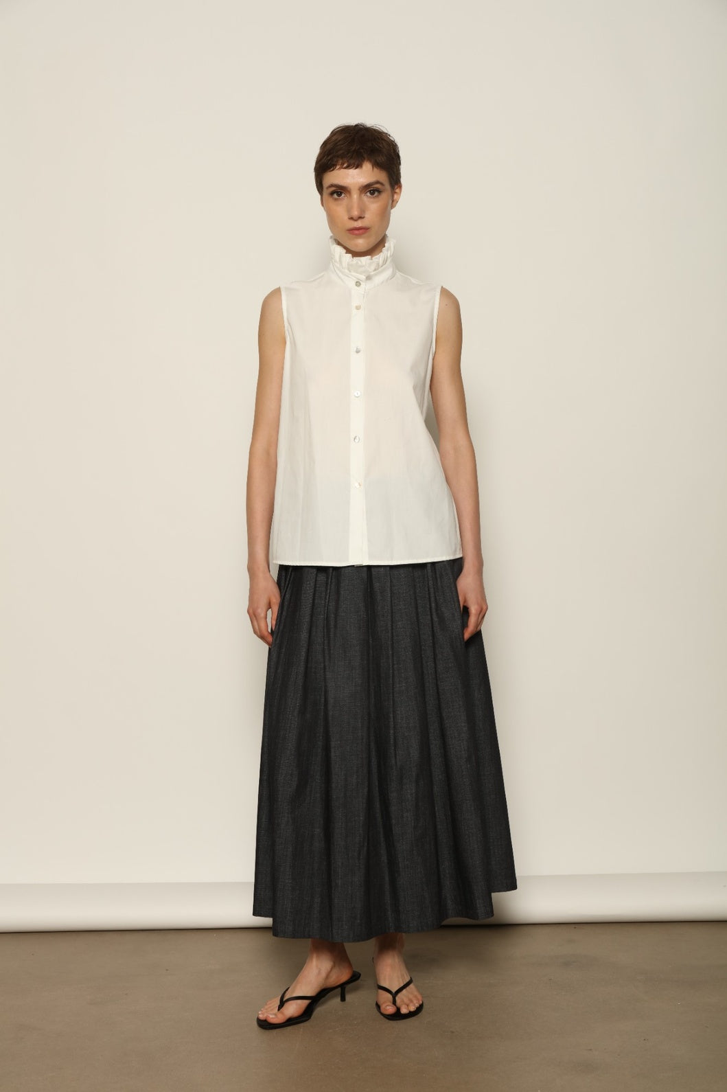 Model wearing the Seoul Ink Denim Skirt by House of Woven Stories, featuring deep indigo denim, a structured silhouette, and refined tailoring for a timeless and elegant look.